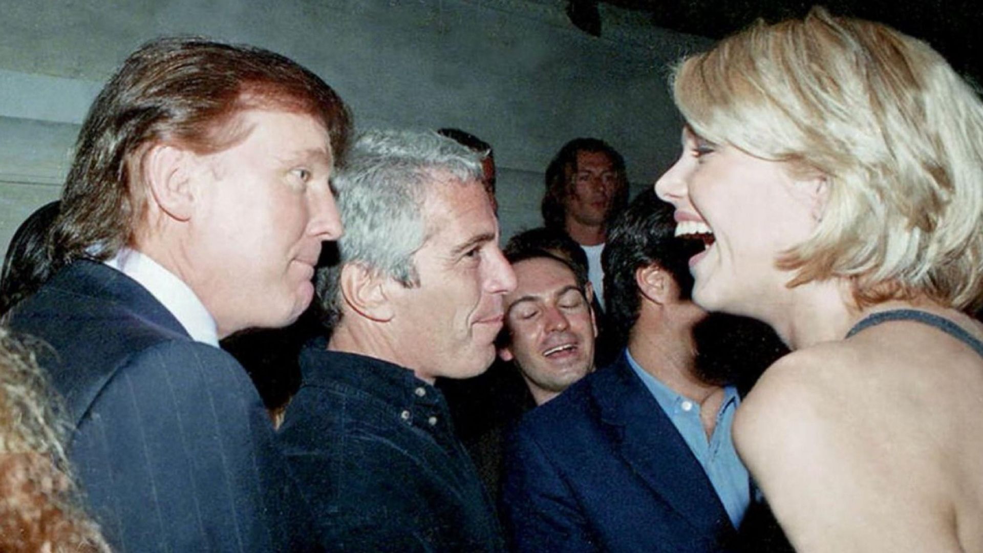 Donald Trump and Jeffrey Epstein with other people at a social event