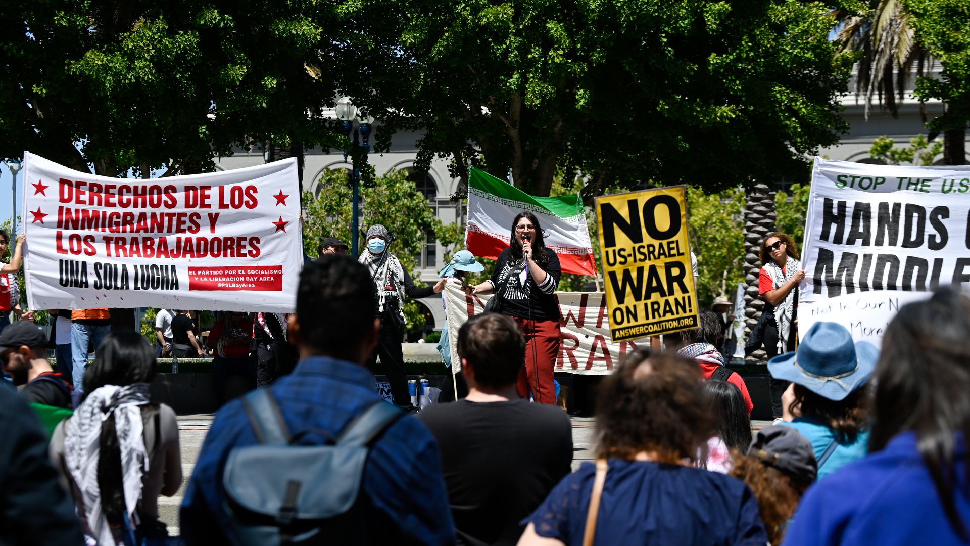 Photo of protesters gathered around a speaker