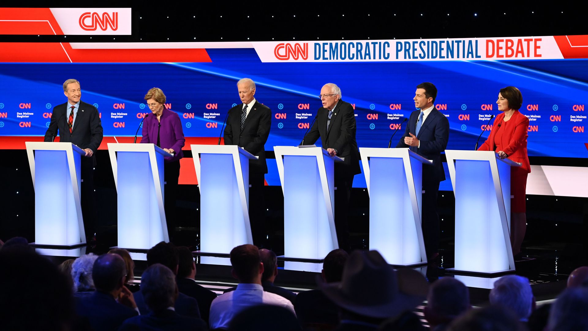 In this image, Biden, Sanders, Buttigieg, Klobuchar, Warren, and Steyer stand at the seventh Democratic debate