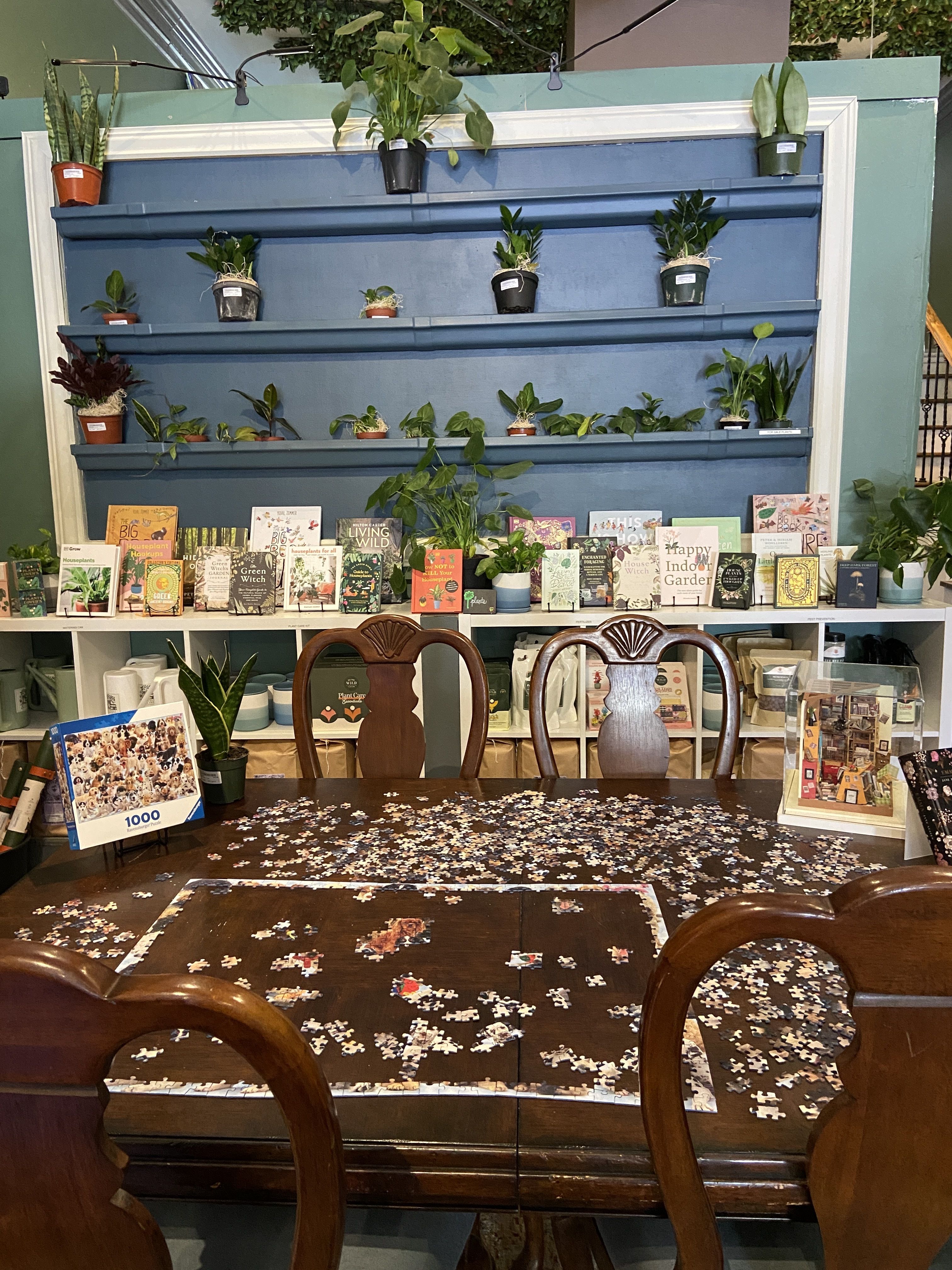 A partially completed puzzle on a table at the back of the bookshop.
