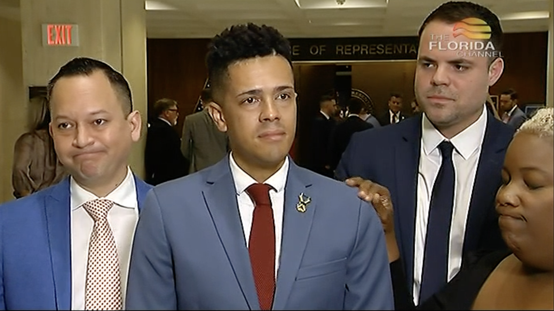 Brandon Wolf speaks with Rep. Michele Rayner's hand on his shoulder