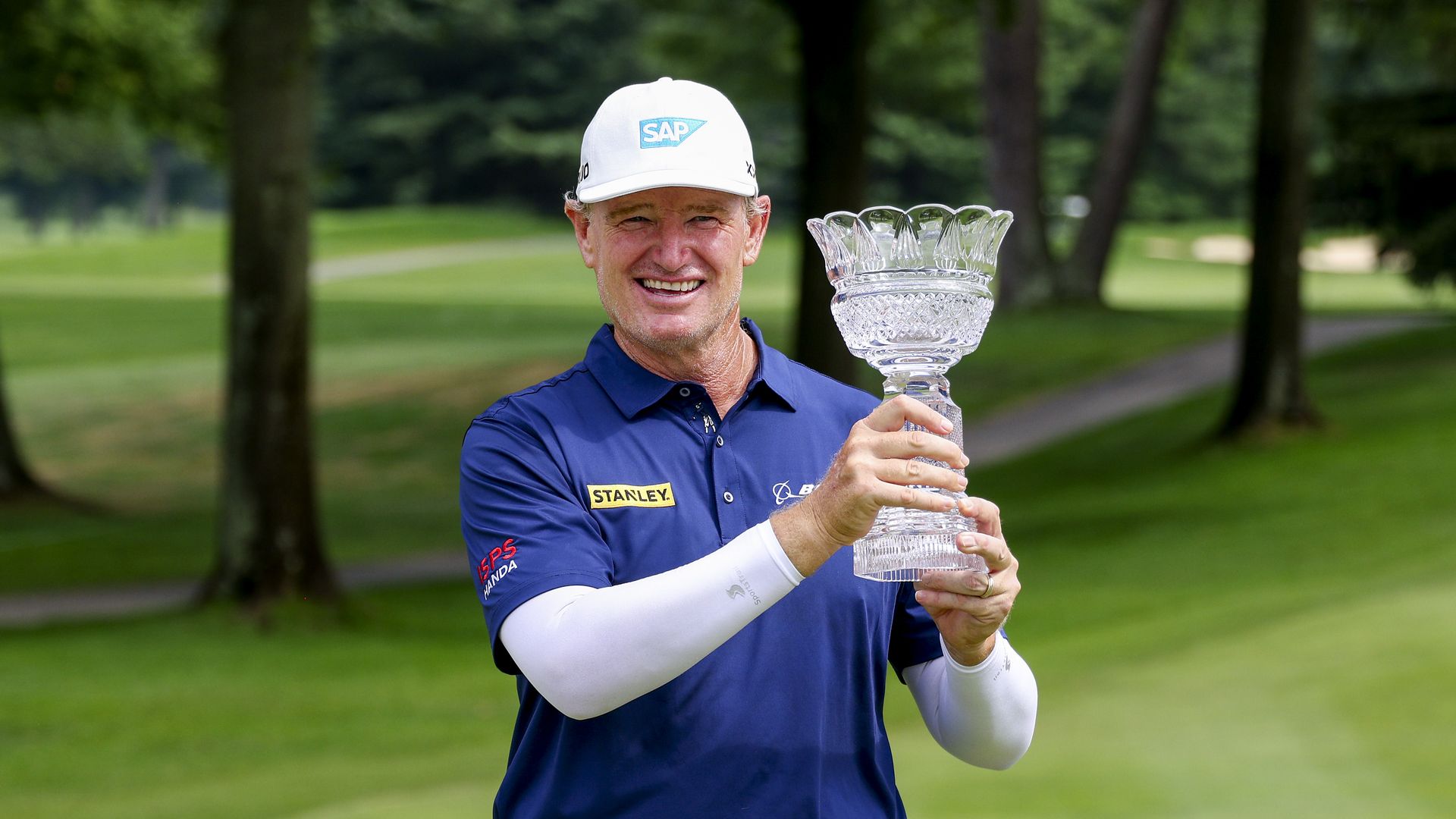Golfer Ernie Else hoists glass trophy