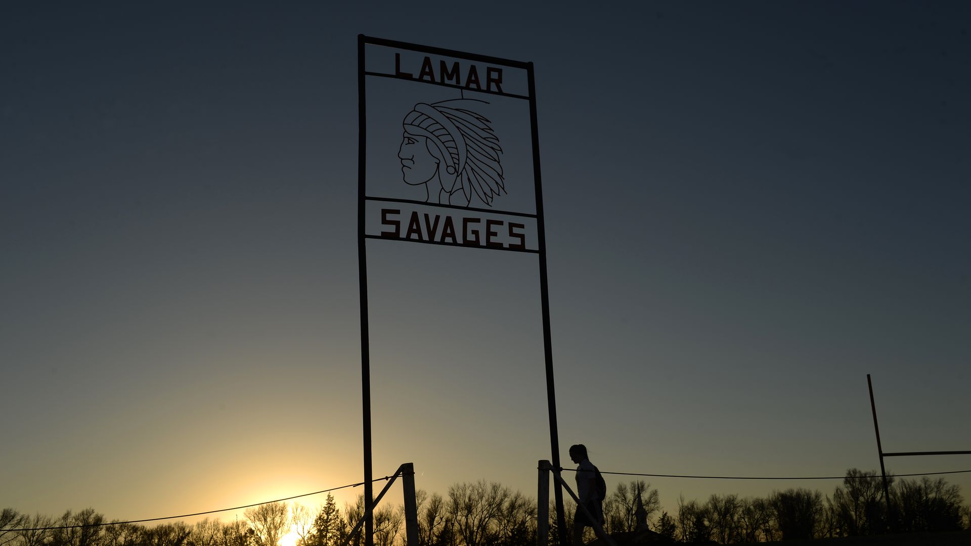 A photo of the sign at Lamar High School that features a symbol of a Native American man and reads "Lamar Savages" 