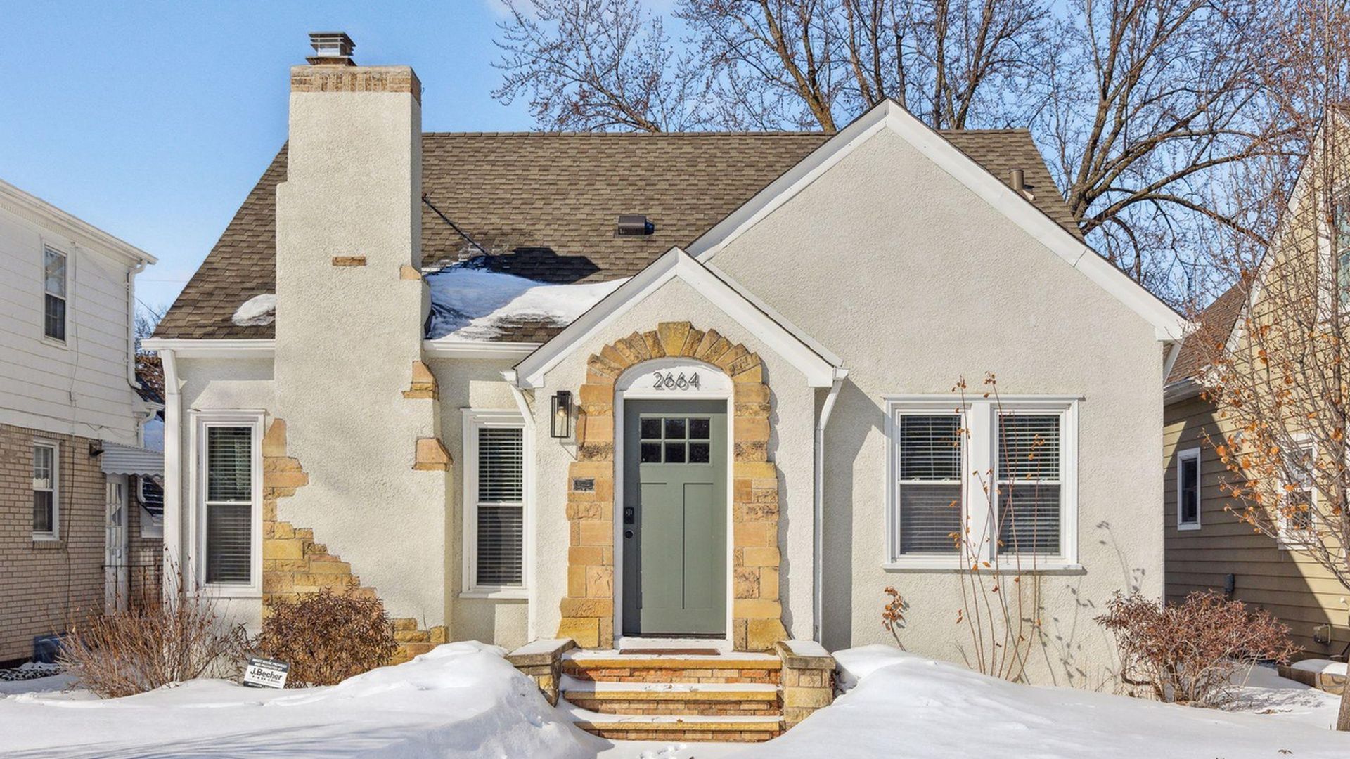 exterior of Tudor-style home with stone detailing
