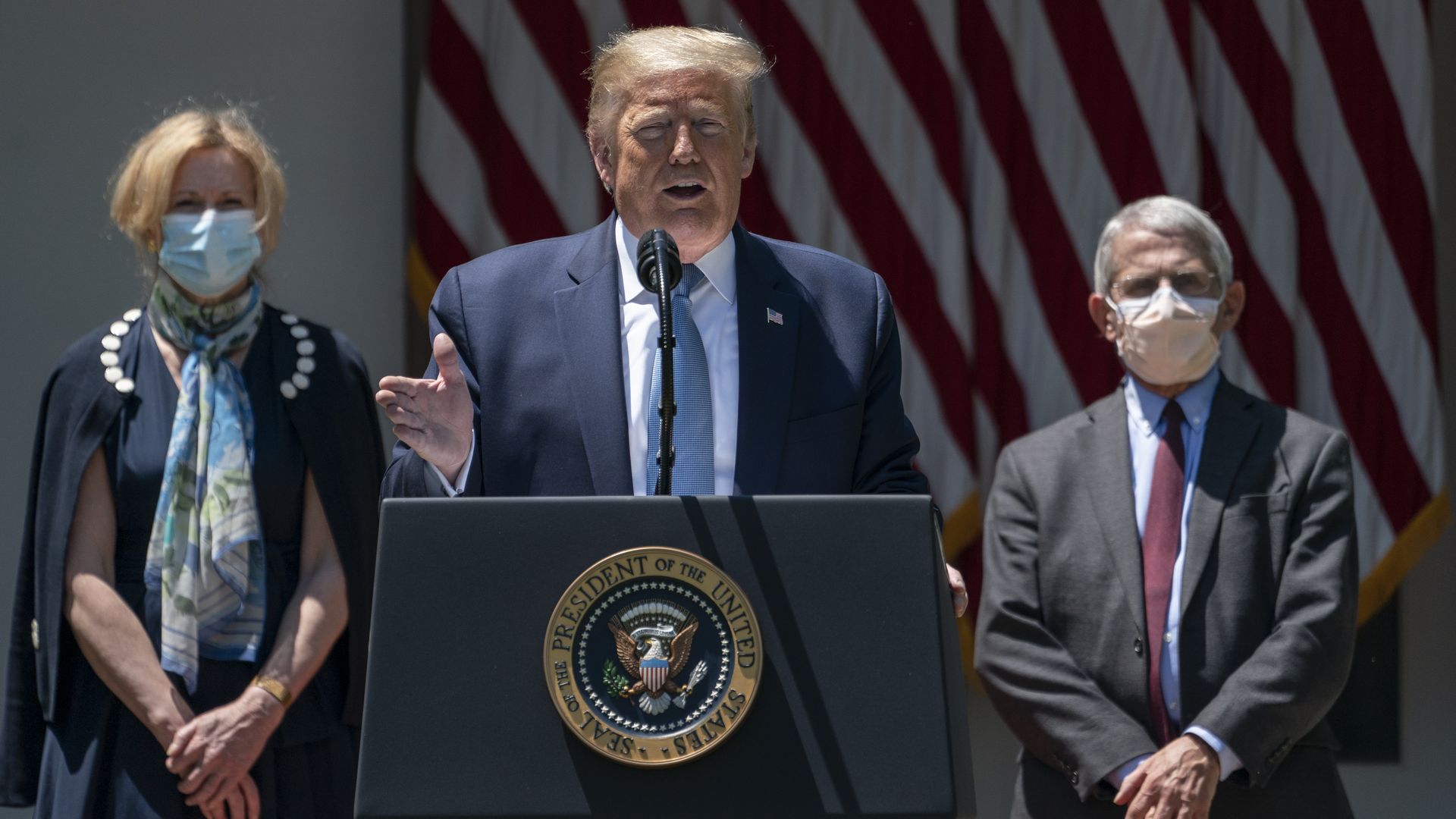 Flanked by Dr. Deborah Birx (L) and Dr. Anthony Fauci (R) President Donald Trump delivers remarks about coronavirus vaccine development  at the White House