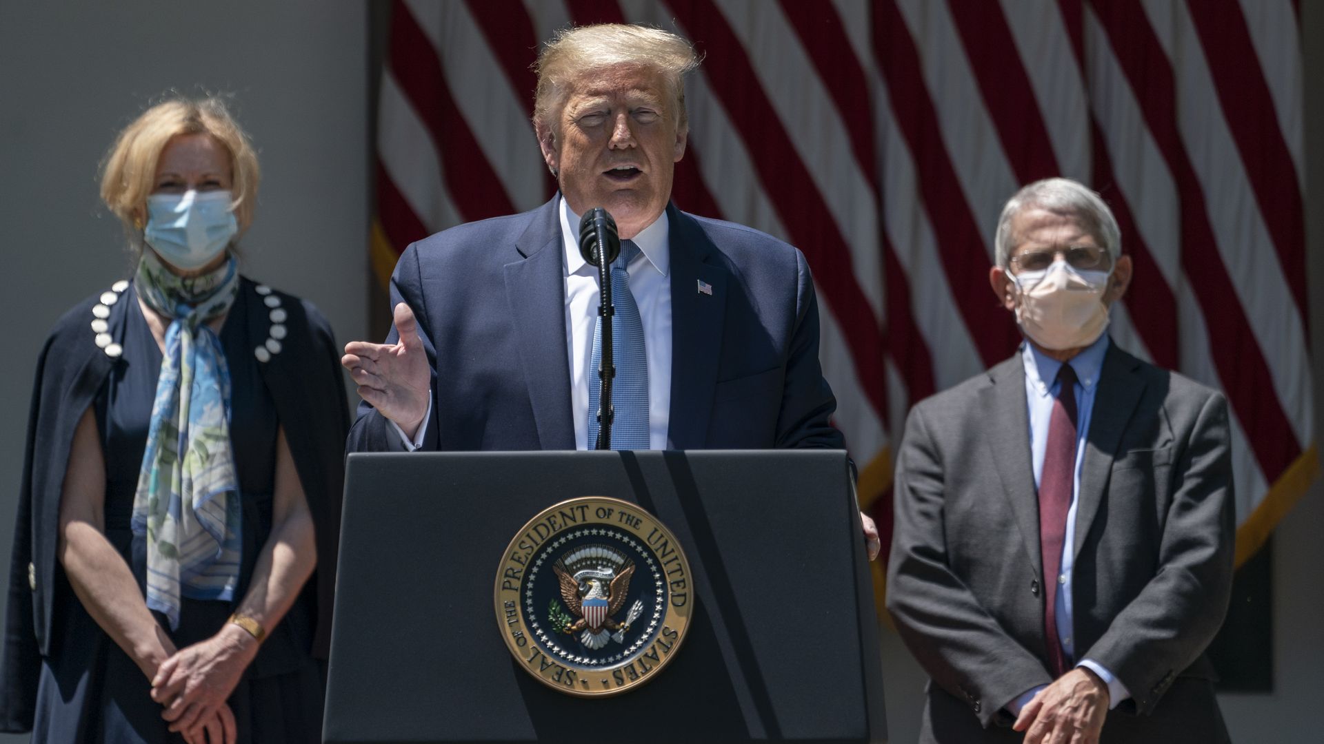 Flanked by Dr. Deborah Birx (L) and Dr. Anthony Fauci (R) President Donald Trump delivers remarks about coronavirus vaccine development at the White House