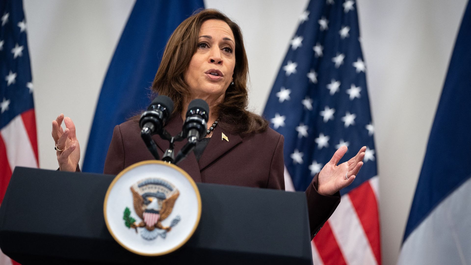 U.S. Vice President Kamala Harris speaks at a podium with an American flag in the background
