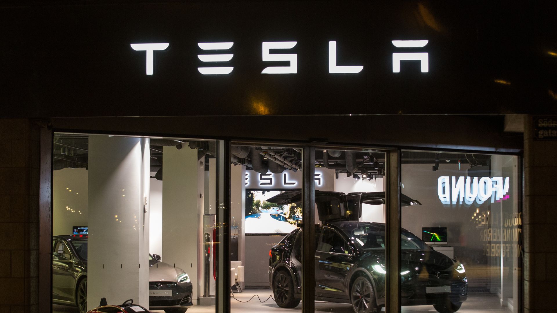 Photo of Tesla display at story lit up at nighttime