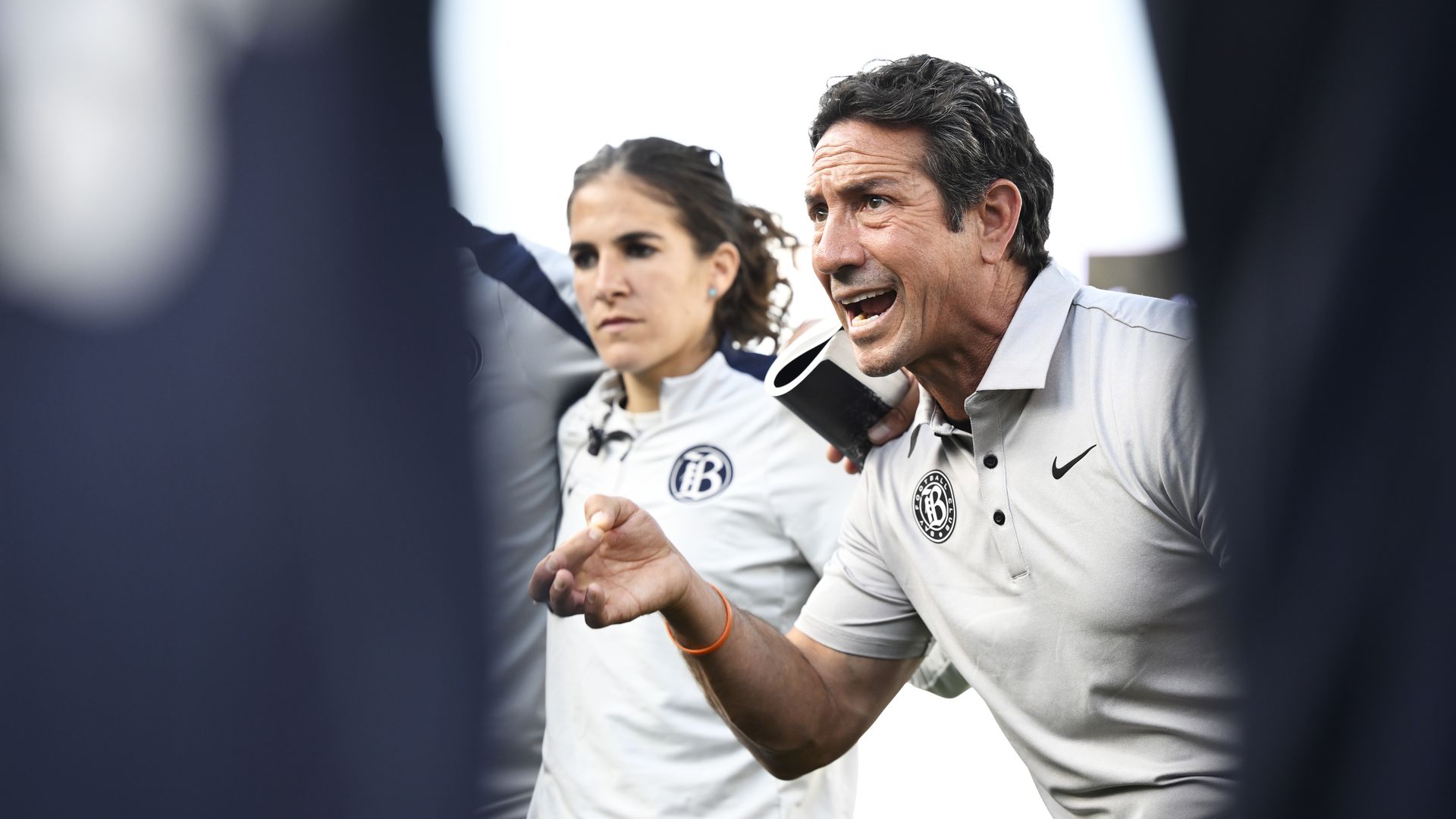 Photo of Albertin Montoya gesturing with his hand in a huddle with Bay FC players