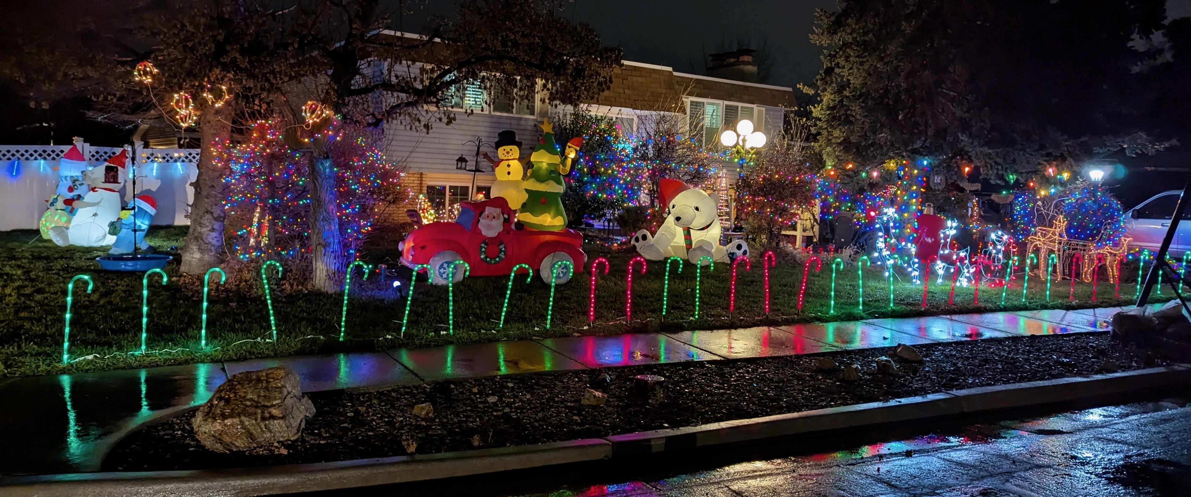 Christmas lights and decorations in front of a house.