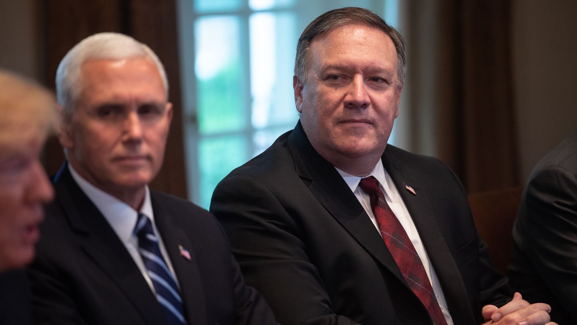 Secretary of State Mike Pompeo and Vice President Mike Pence listen to President Donald Trump during a White House meeting. 