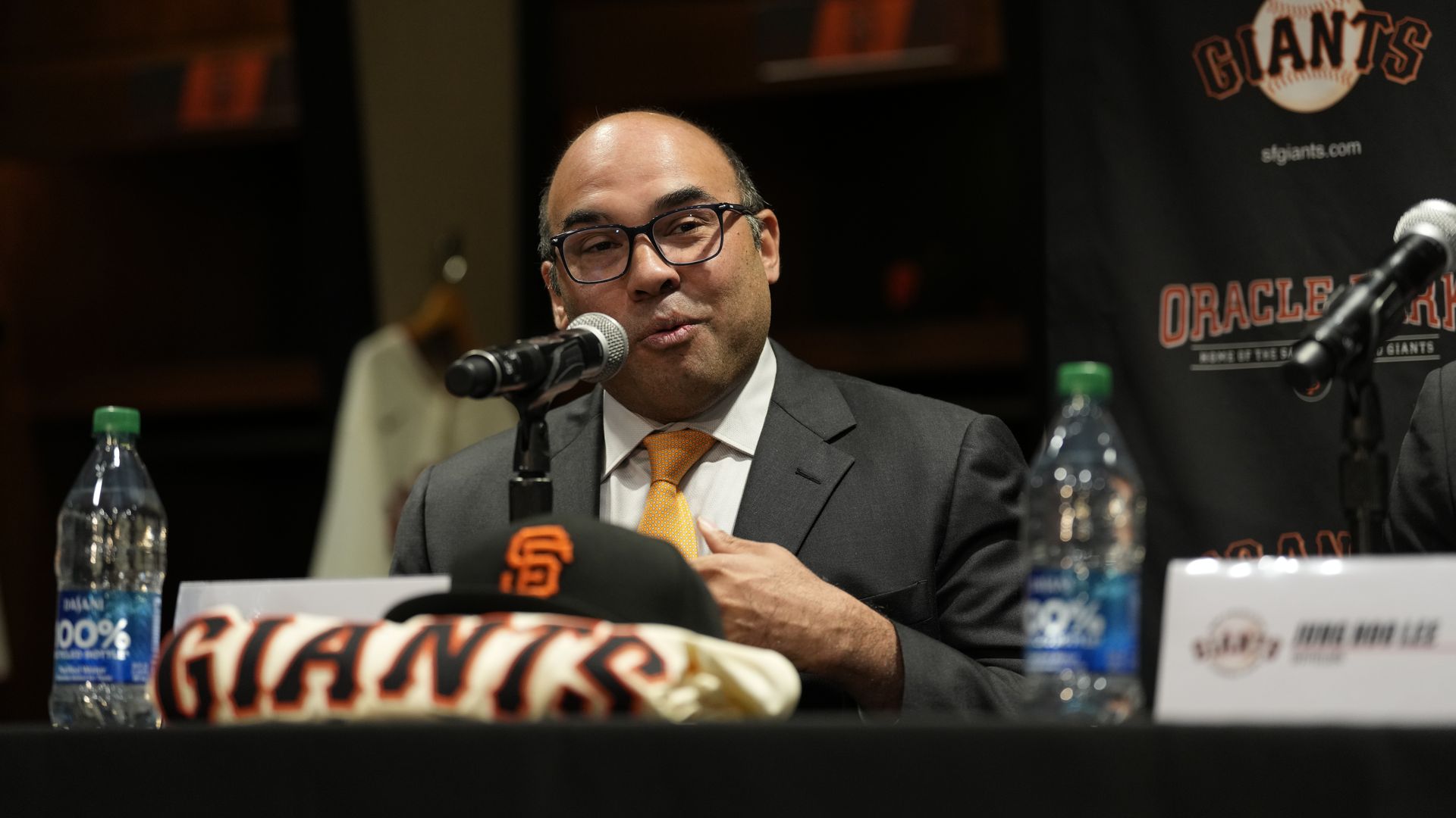 Photo of Farhan Zaidi speaking into a mic at a Giants press conference