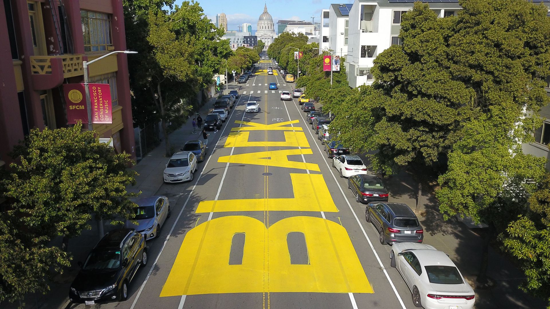 An aerial photo shows a giant street mural reading "Black Lives Matter" spanning three city blocks near City Hall in San Francisco, California on June 12, 2020. - The May 25 killing of George Floyd, an African American, by a white police officer in Minneapolis has ignited mass protests for racial ju