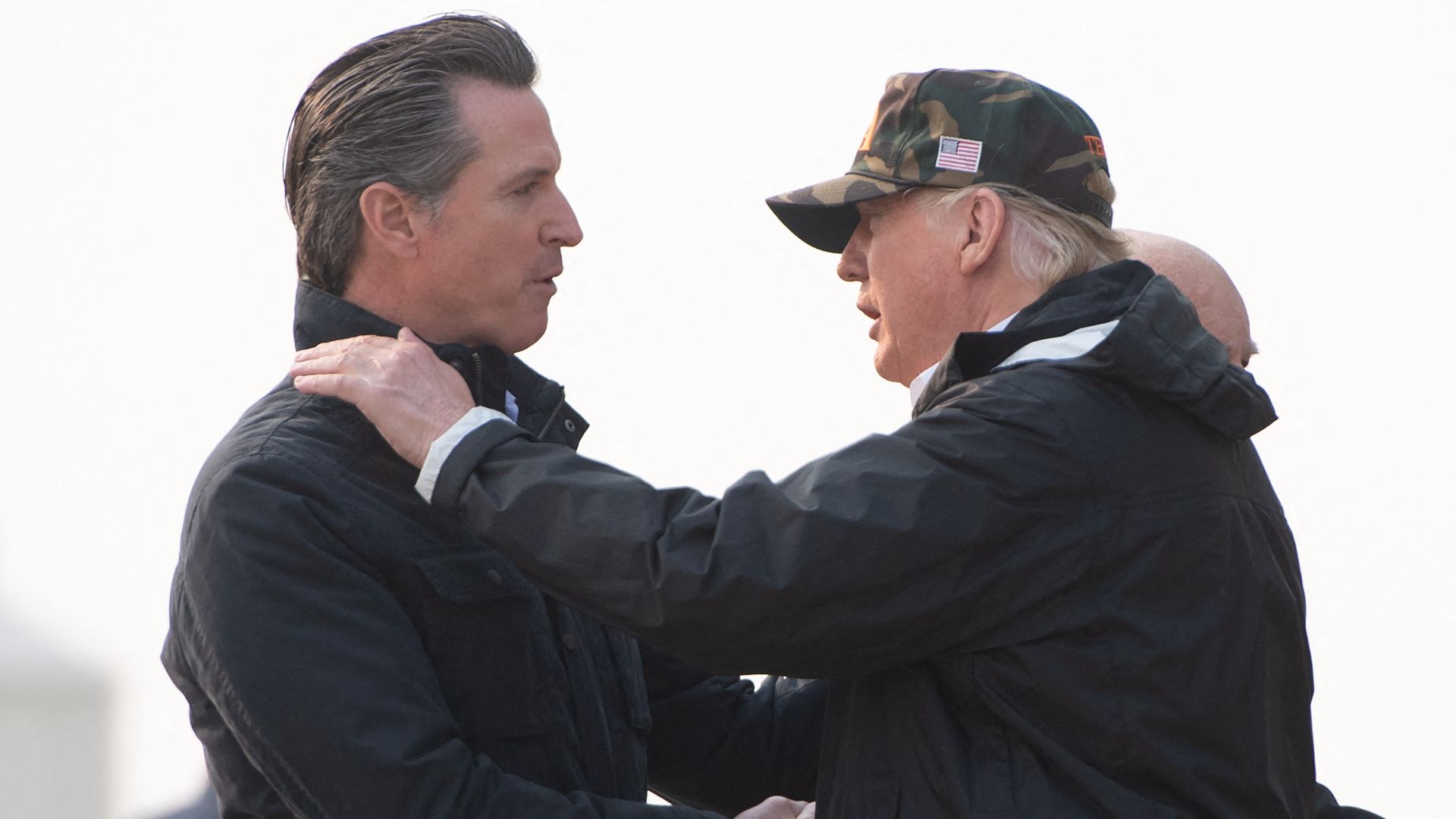 US President Donald Trump greets California Governor-elect Gavin Newsom (L) as he disembarks from Air Force One upon arrival at Beale Air Force Base in California, November 17, 2018, as he travels to view wildfire damage. President Donald Trump arrived in California to meet with officials, victims a
