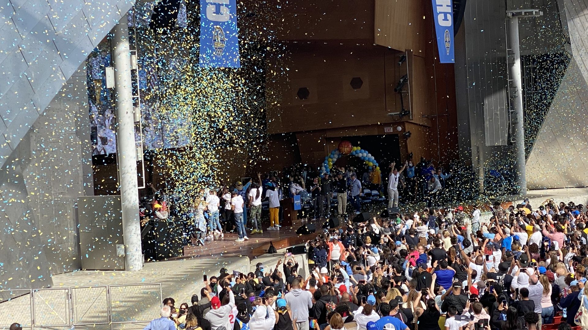 Confetti is dropped all over the stage at a championship rally. 