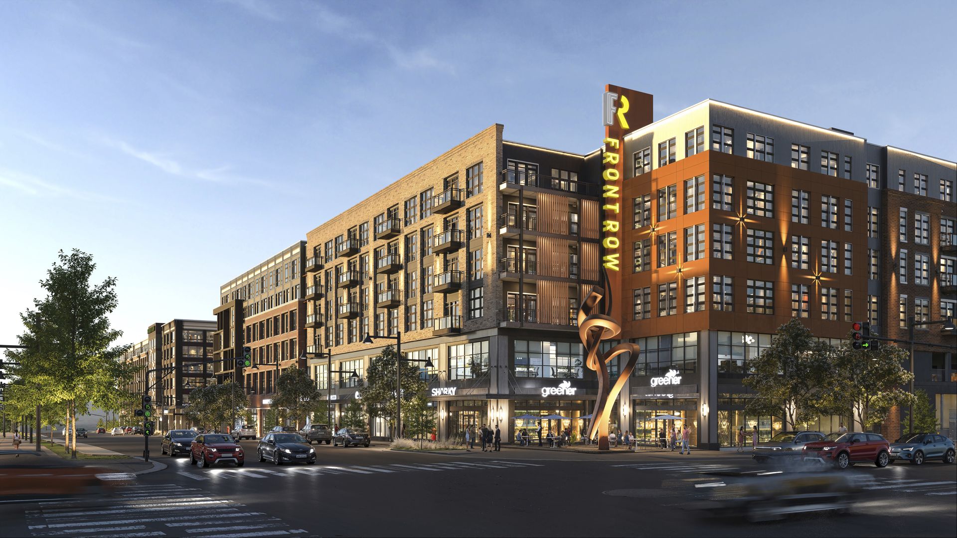 Urban street scene at sunset with a modern mixed-use building featuring shops like "SHARKY" and "greener" and a large illuminated sign reading "FRONTROW" with an artistic sculpture.