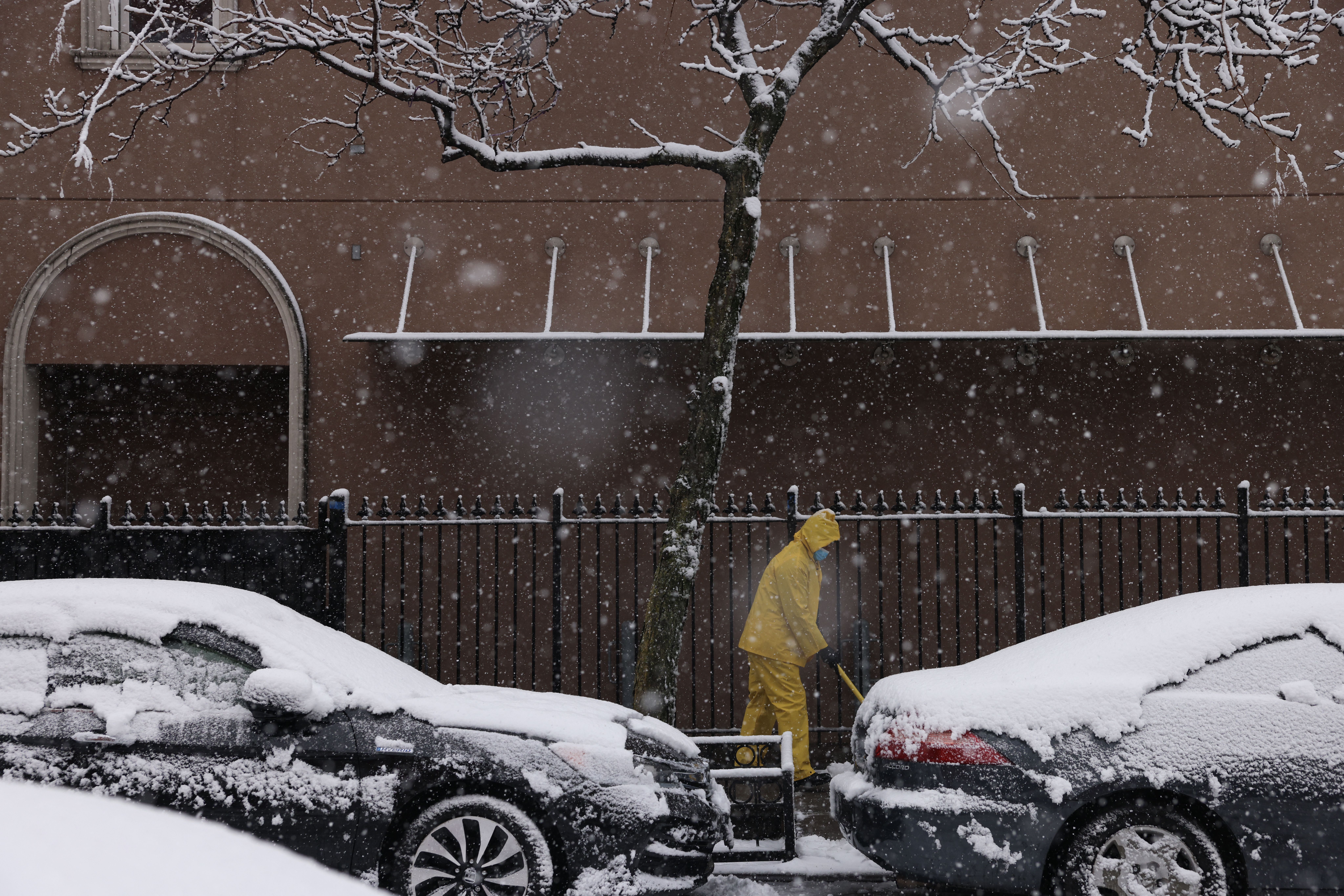  A person shovels the sidewalk as snow falls in the Brooklyn borough of New York City on February 13, 2024. Heavy snowfall is expected over parts of the Northeast US starting late February 12, with some areas getting up to two inches (5cms) of snow an hour, the National Weather Service forecasters said.