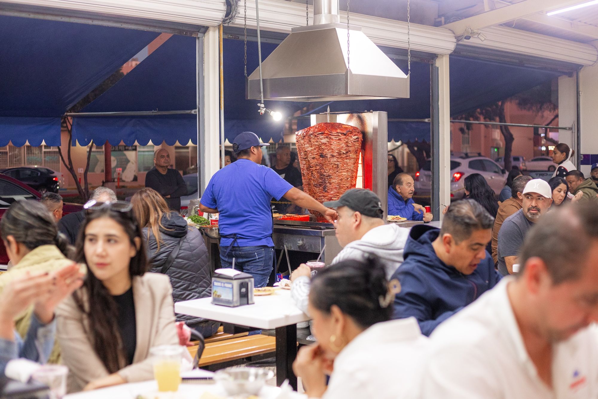 People eat at a busy taqueria in Tijuana.