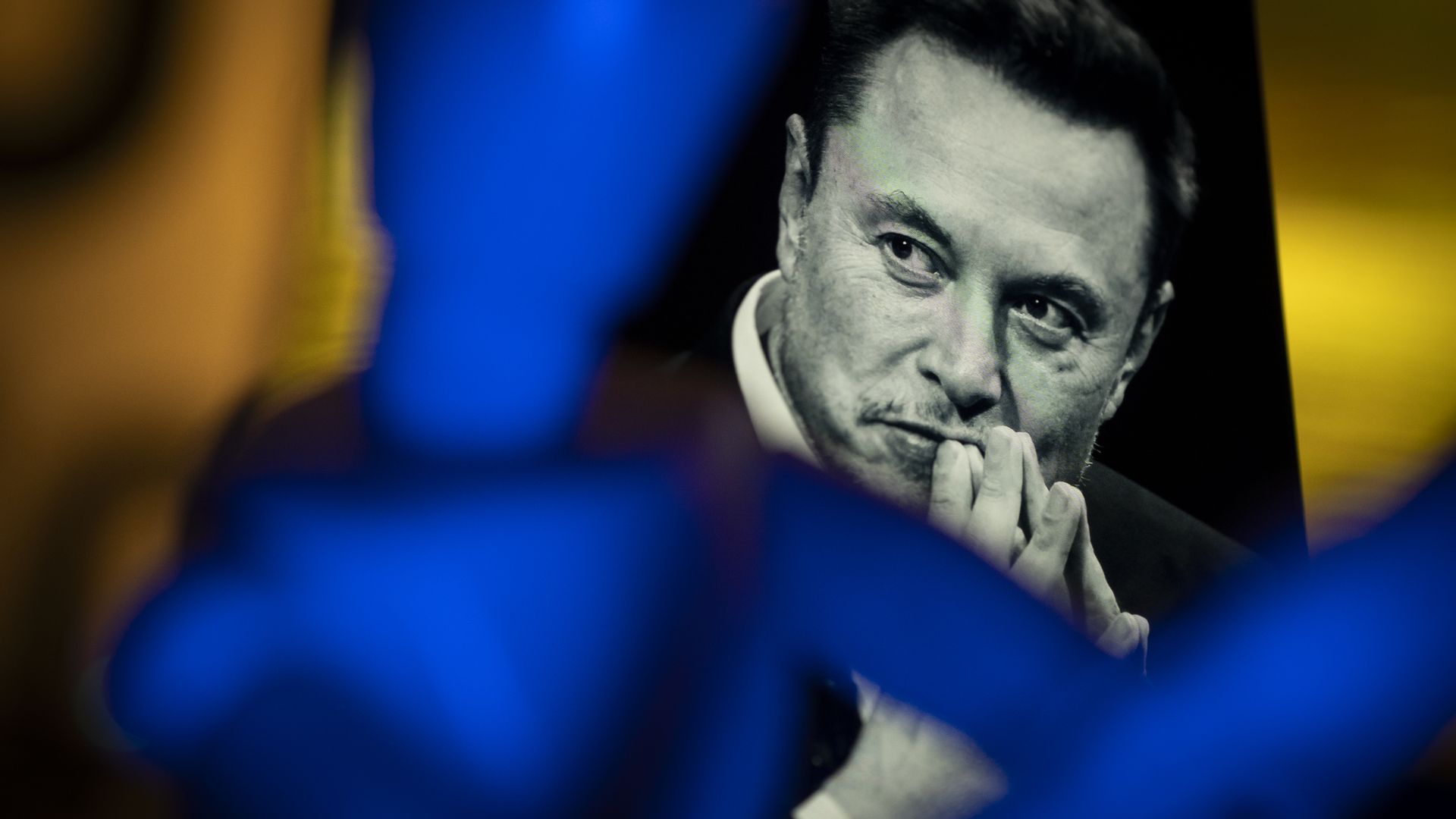 An image of Elon Musk is seen displayed on a mobile device with the Twitter and X logos in this illustration photo on 15 November, 2023. 