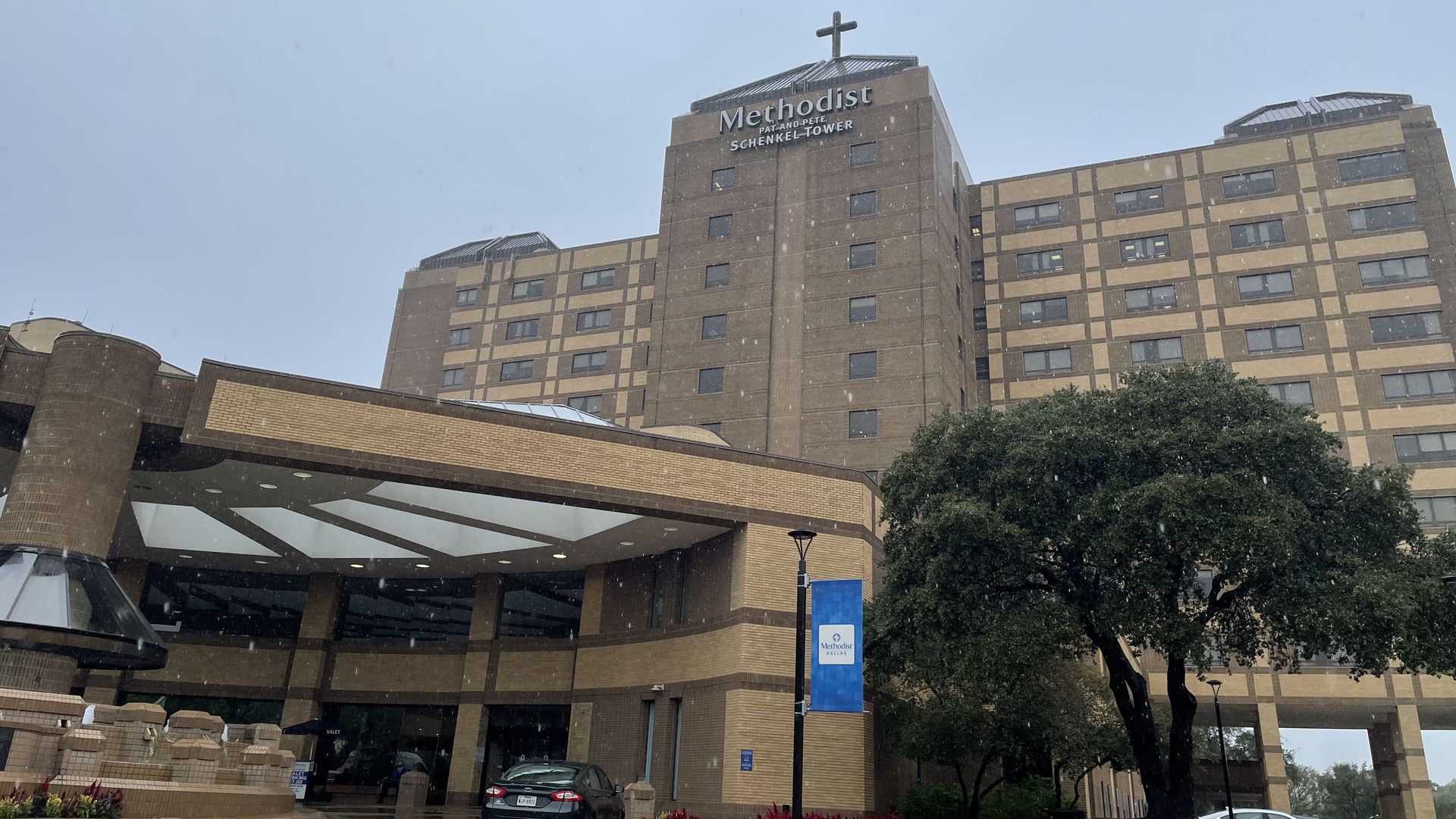 A tall hospital on a rainy day