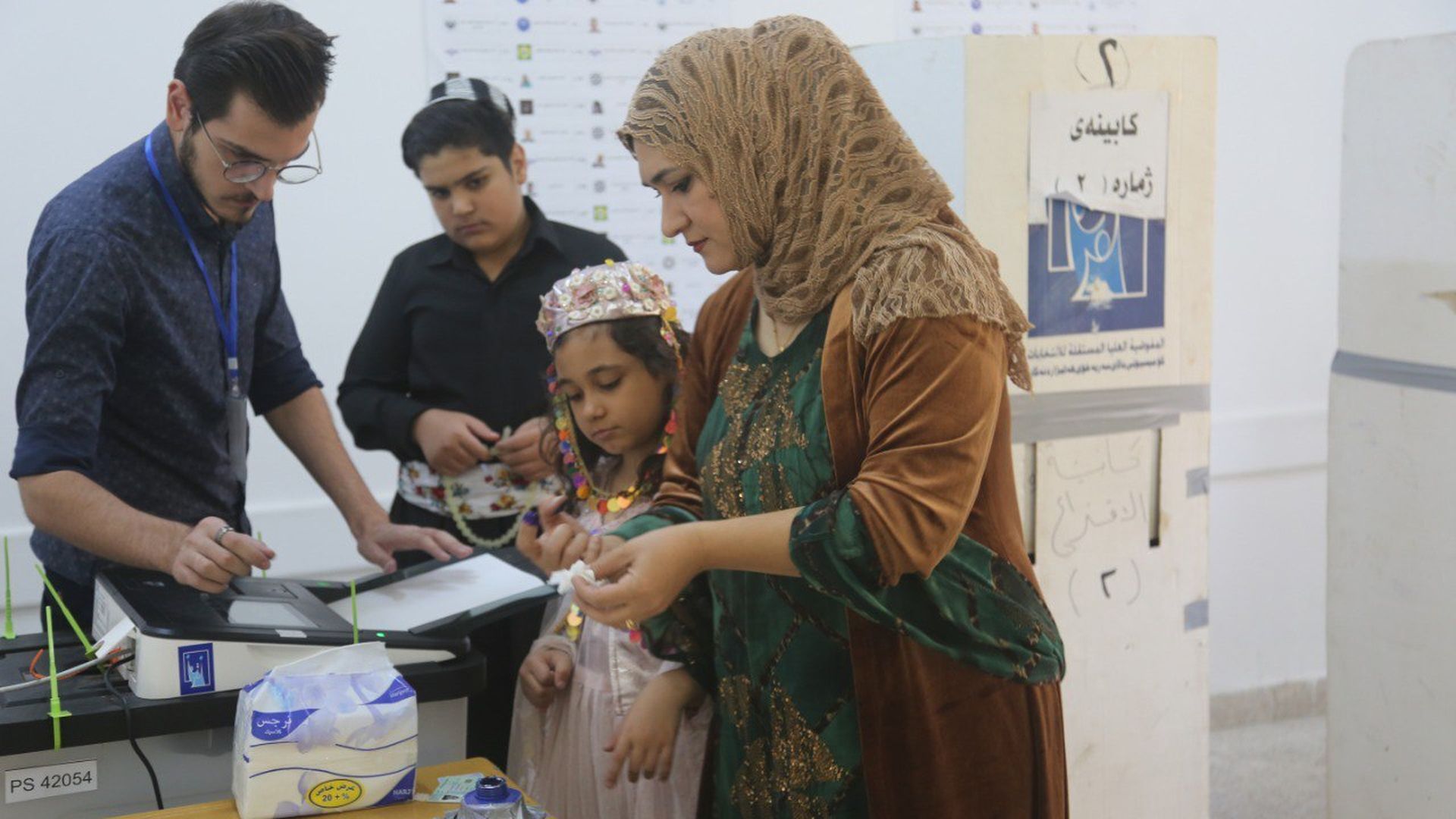 Iraqi voters cast their ballots at a polling station in the country's early general election in Sulaymaniyah, Iraq on October 10, 2021 