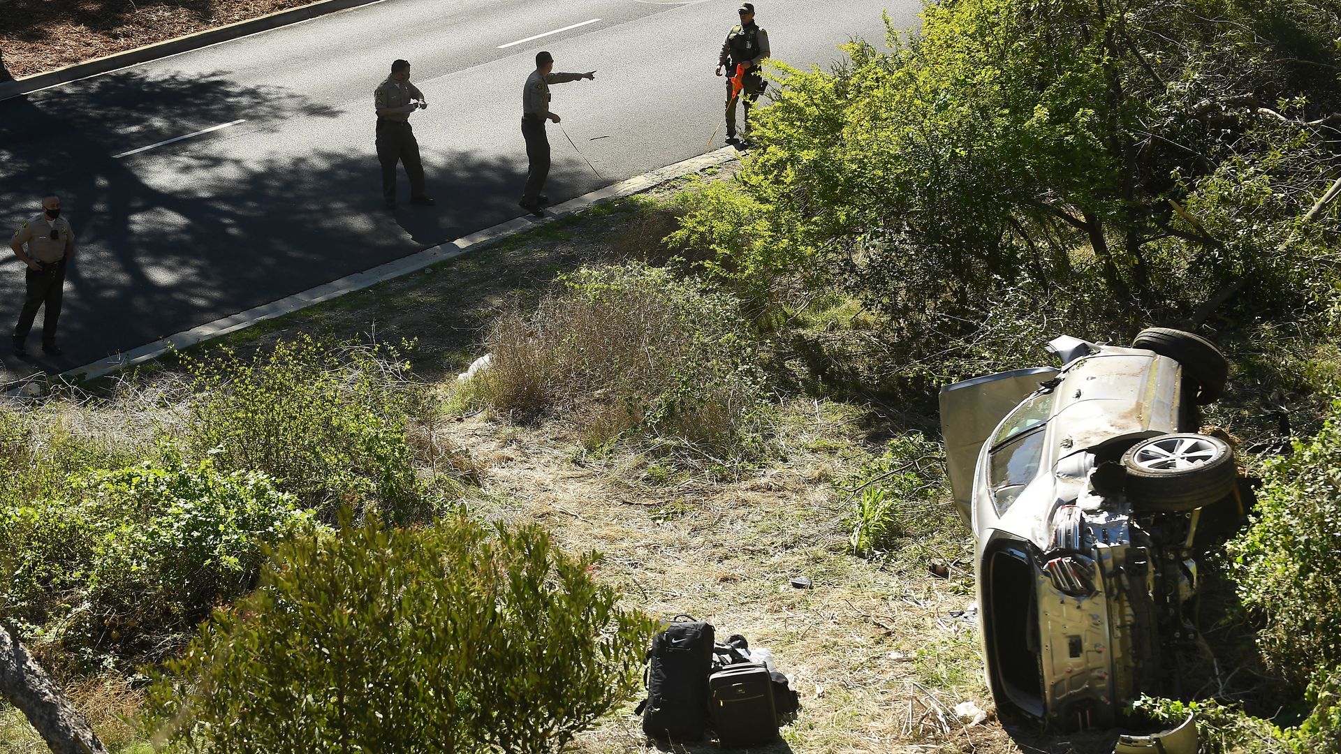 The scene of Tiger Woods' car crash with police surrounding it.