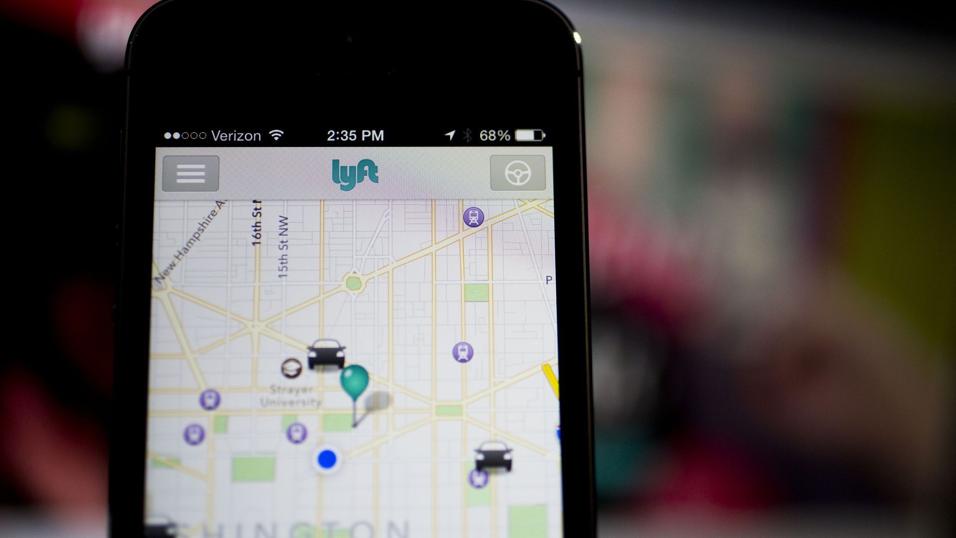Picture of an iPhone with the screen showing a view of the Lyft app