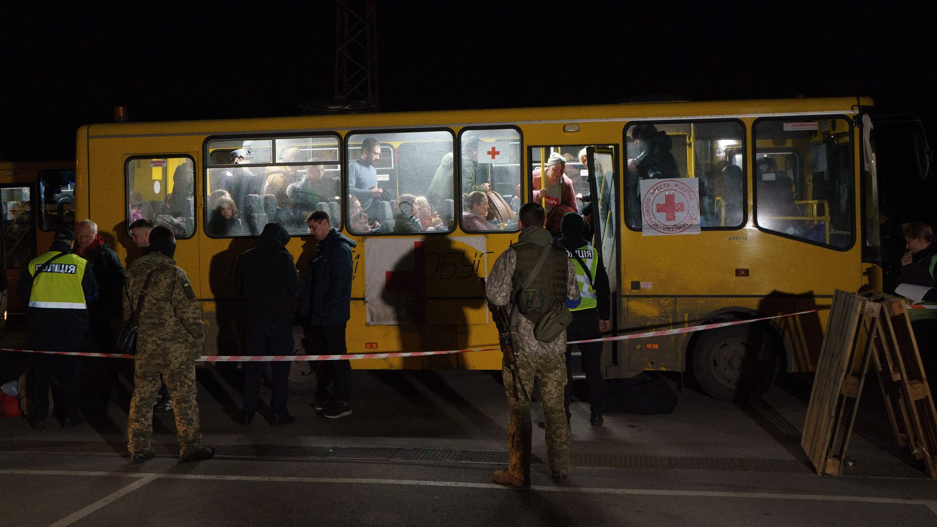 Passengers disembark as a convoy of 30 buses carrying evacuees from Mariupol and Melitopol arrive at the registration center in Zaporizhzhia, on April 1, 2022