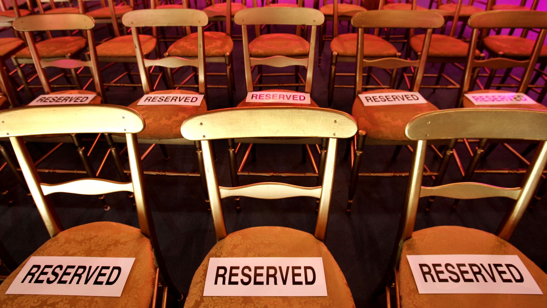 Rows of chairs with "reserved" signs on the seats.