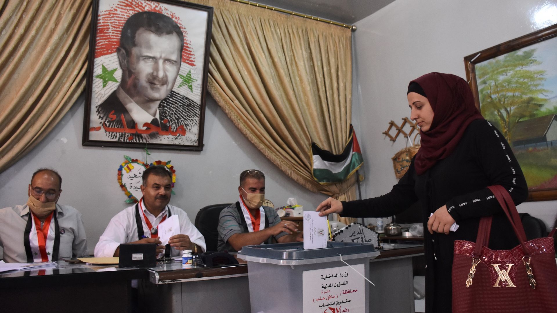  A Syrian woman casts her ballot at a polling station in the Nubl neighbourhood of Aleppo on July 19