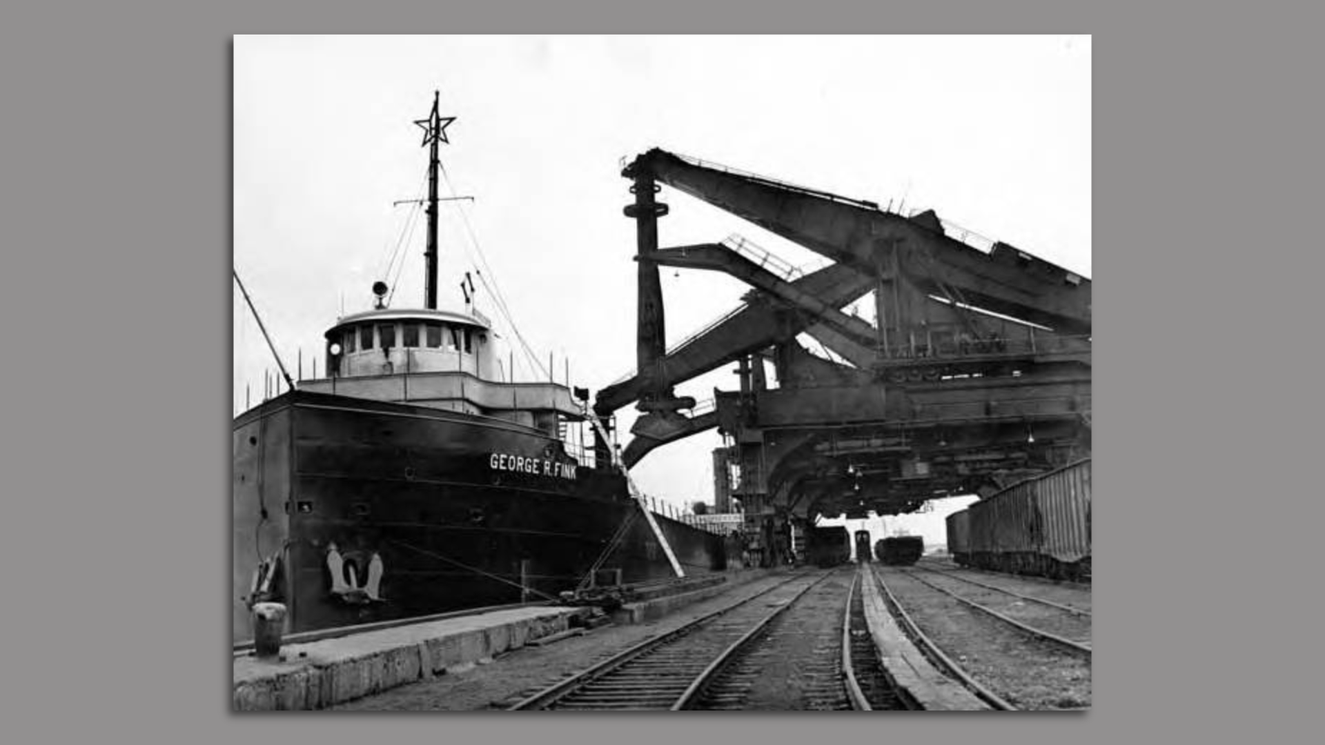 Historical black and white photo of Hulett Unloaders in action at Cleveland's bulk terminal