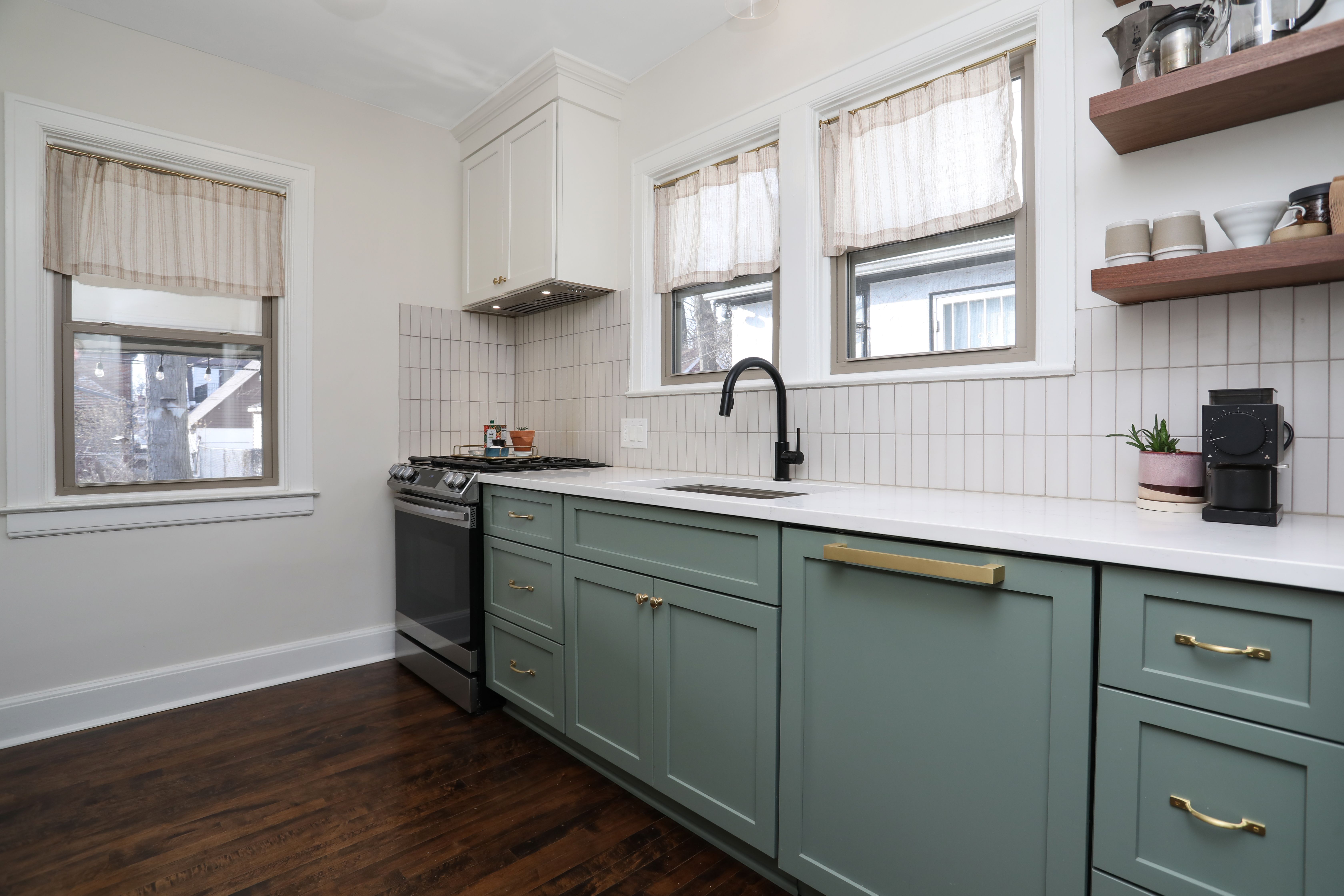 The custom kitchen has stainless steel appliances, a built-in microwave, and a dishwasher with a panel to match the cabinetry.