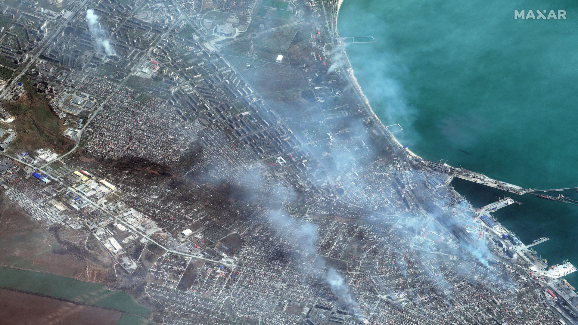 Maxar satellite imagery of buildings on fire in western Mariupol, Ukraine on April 9, 2022.