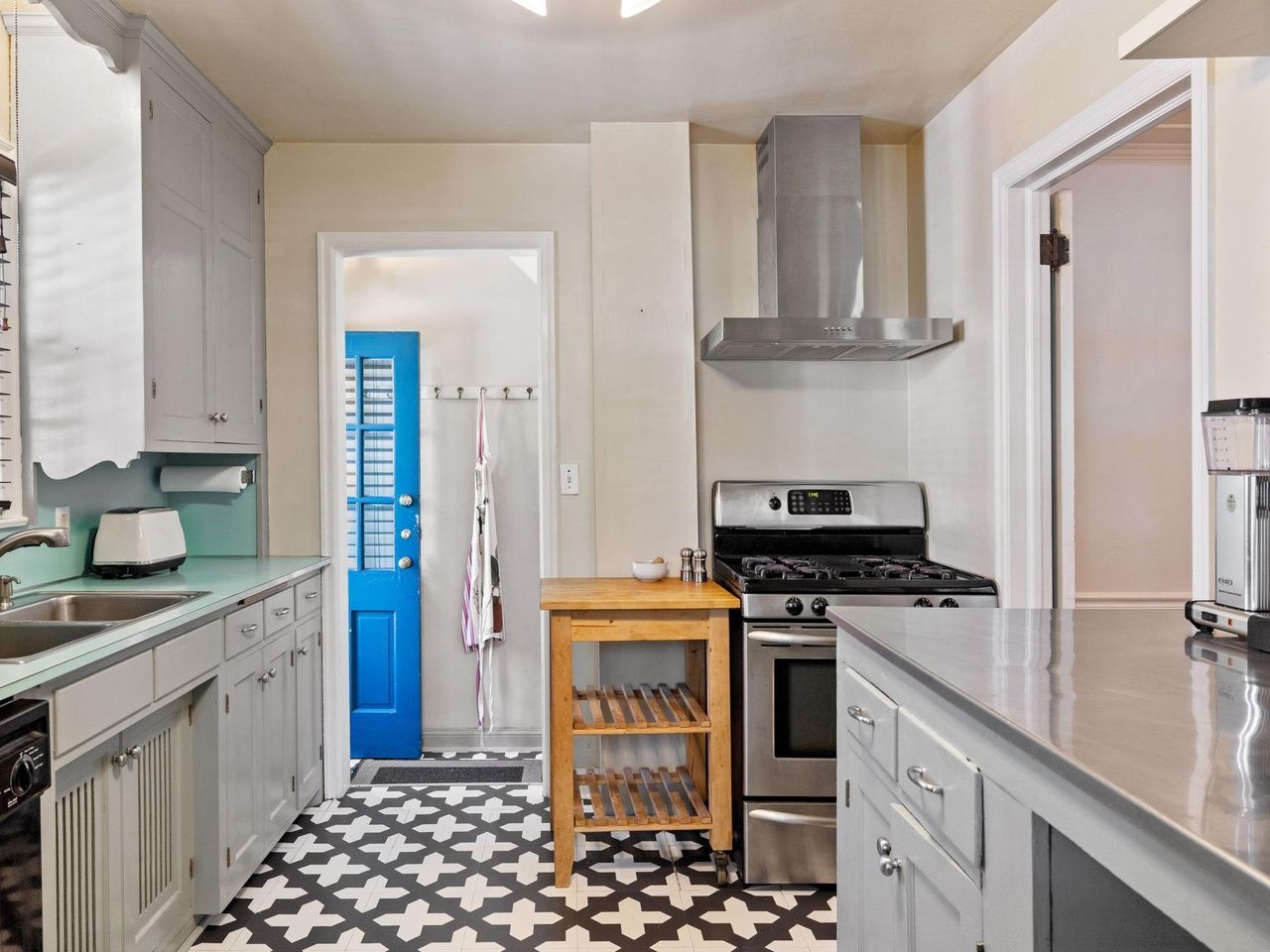 kichen with patterned floors and stainless appliances