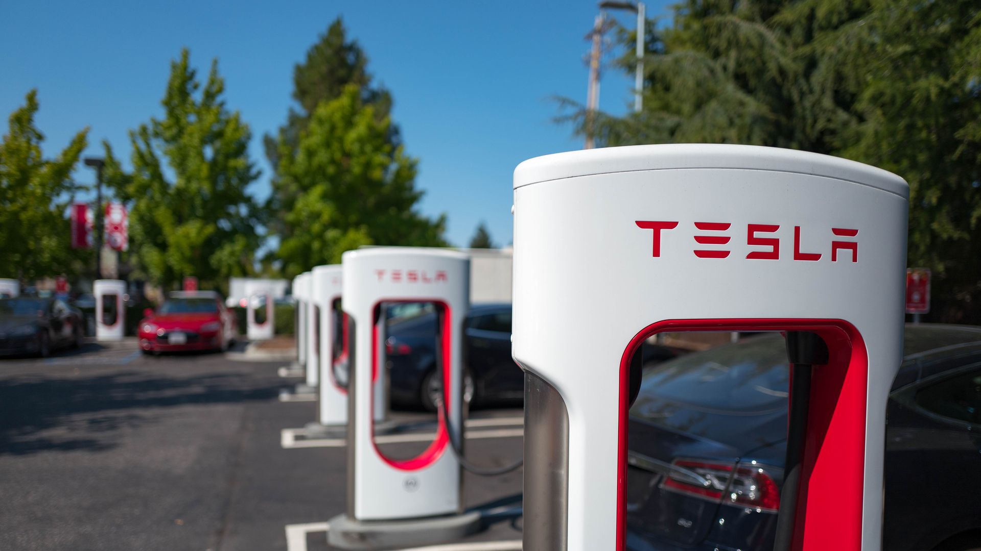 Photo of Tesla electric car chargers in a parking lot. 