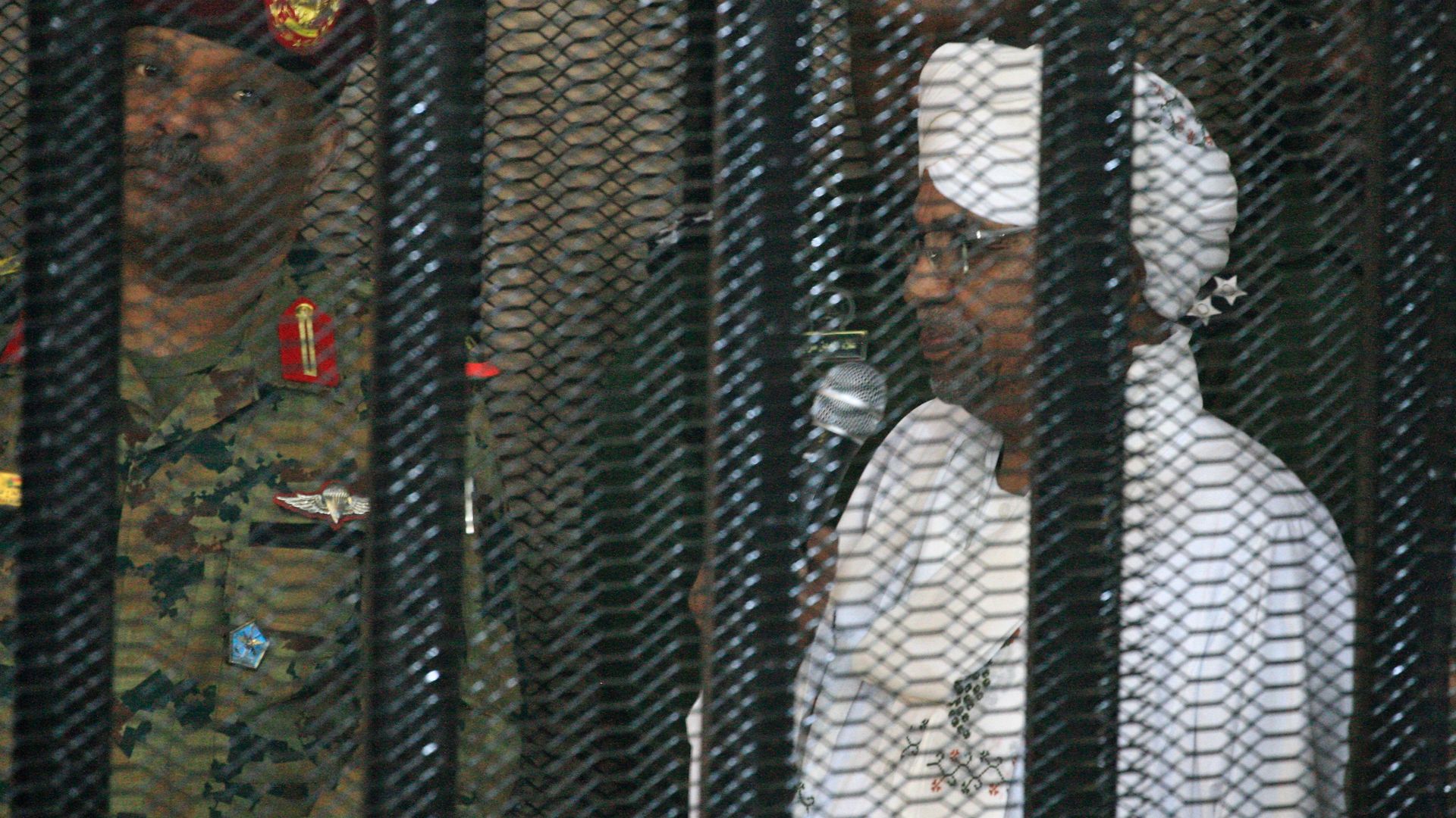 Sudan's former dictator Omar al-Bashir in a defendant's cage
