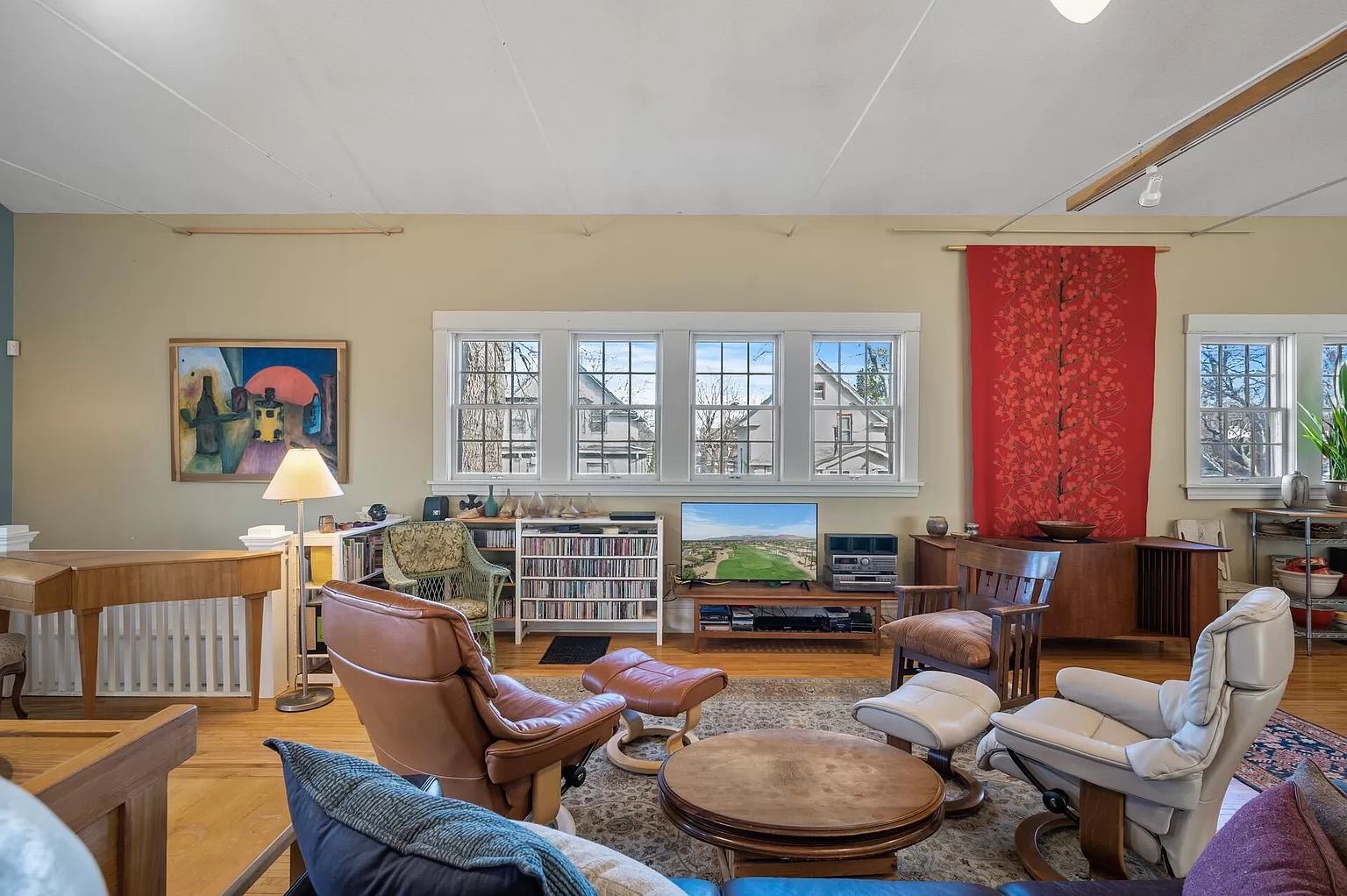 A photo of a living space with chairs and couches.