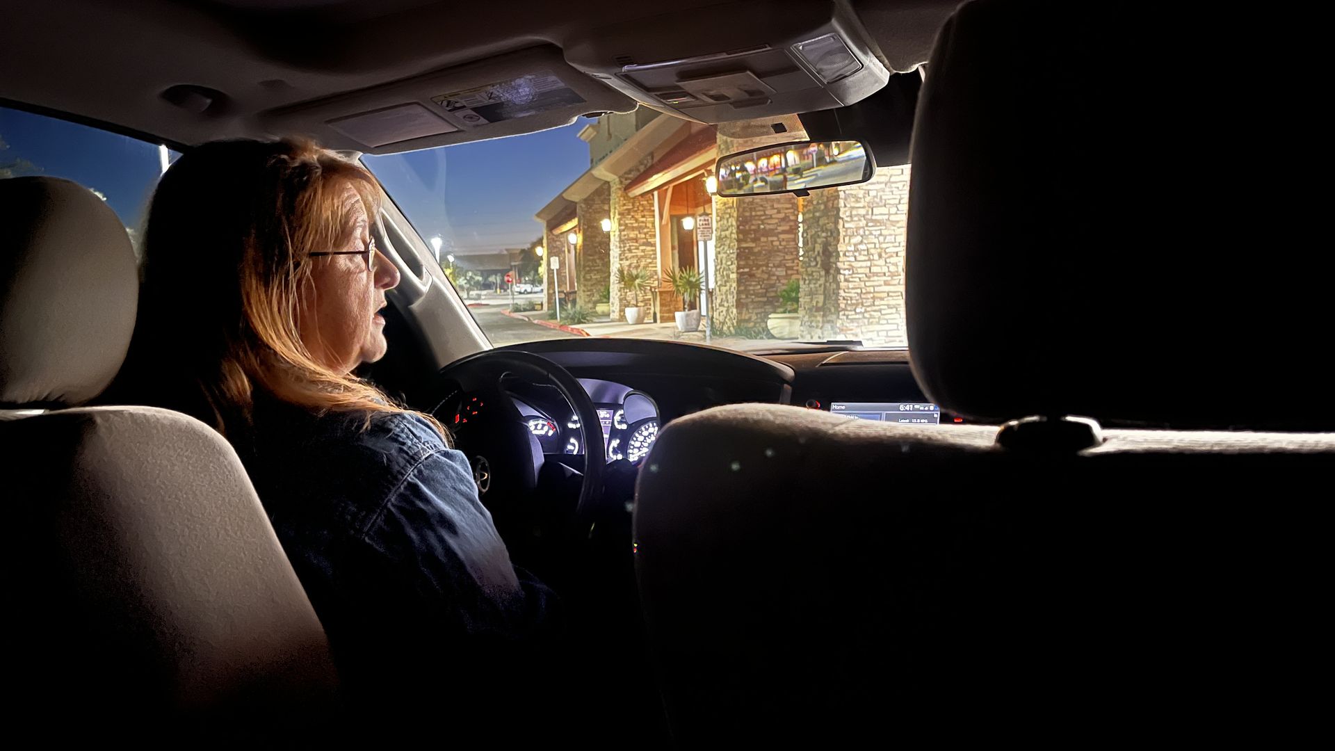 A woman in the driver's seat of a car. 