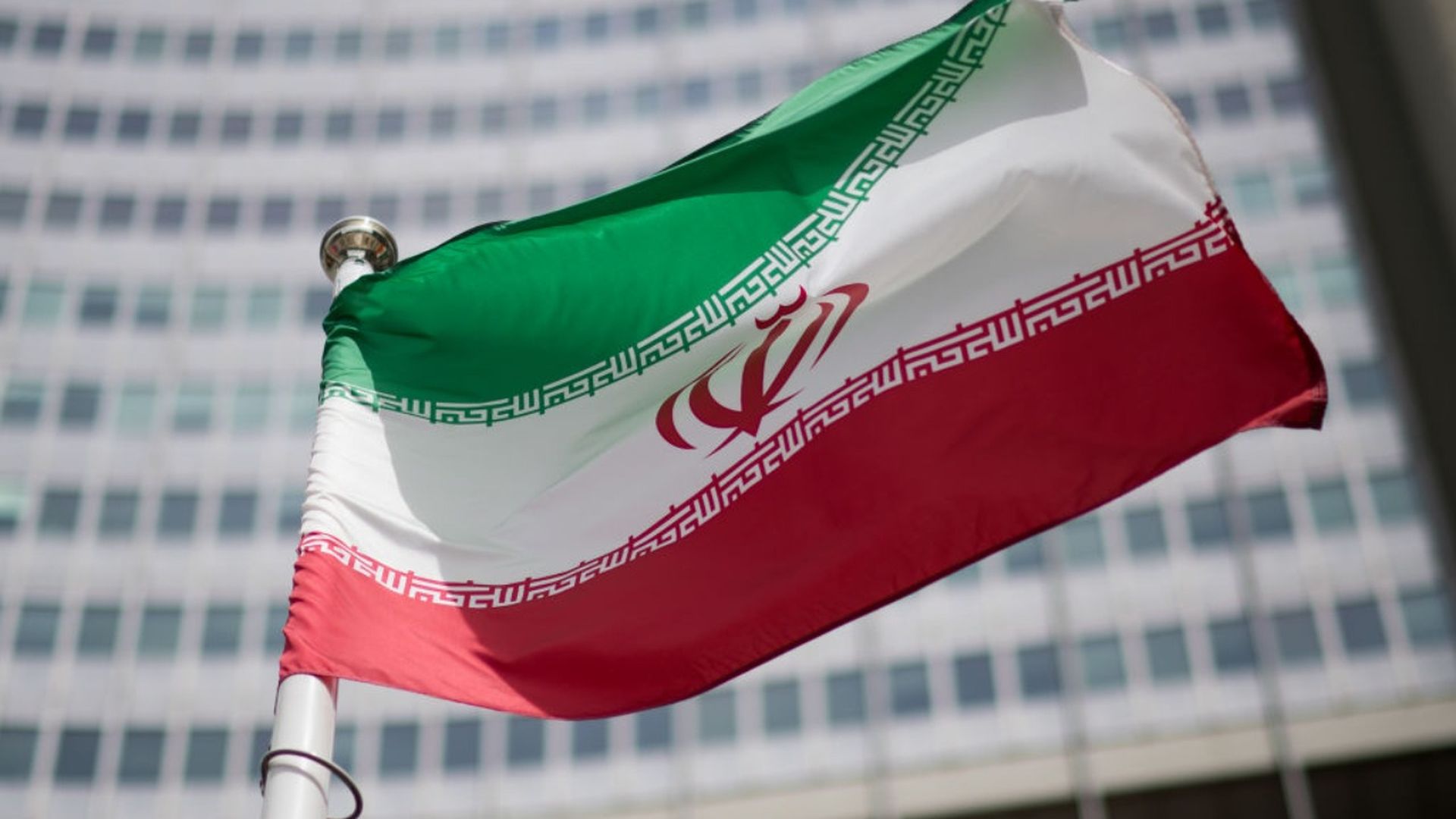 The flag of Iran is seen in front of the building of the International Atomic Energy Agency (IAEA) Headquarters