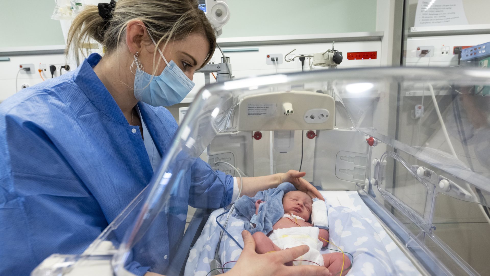 A nurse cares for a baby in a hospital