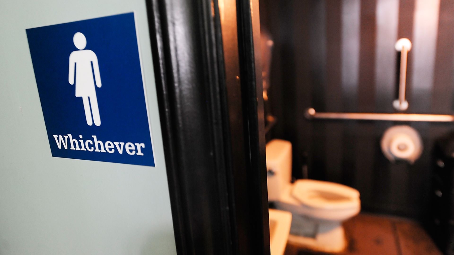 A gender neutral sign posted outside a bathroom at Oval Park Grill in Durham, North Carolina. Photo: Sara D. Davis/Getty Images