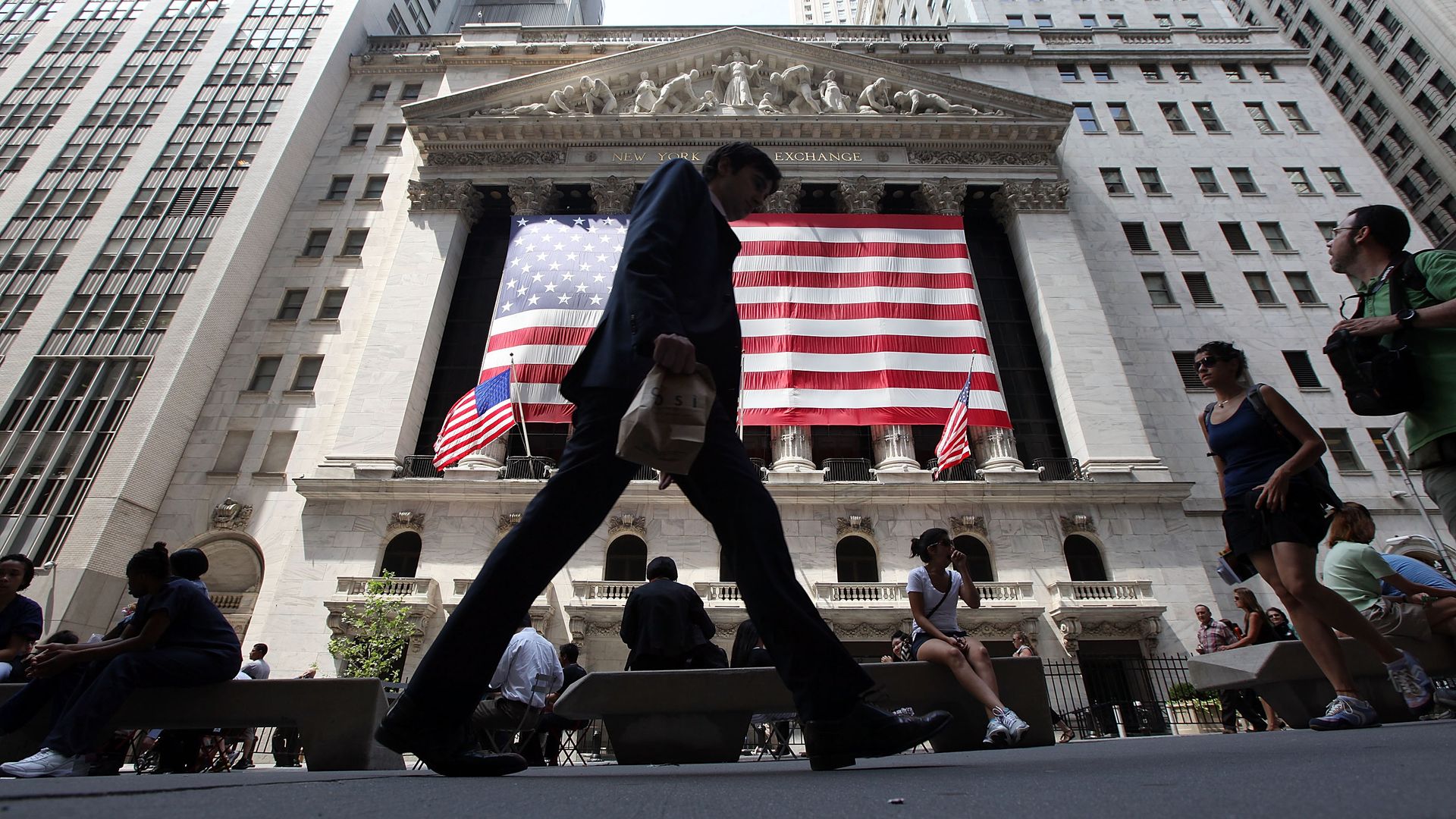 People walk past the New York Stock Exchange.
