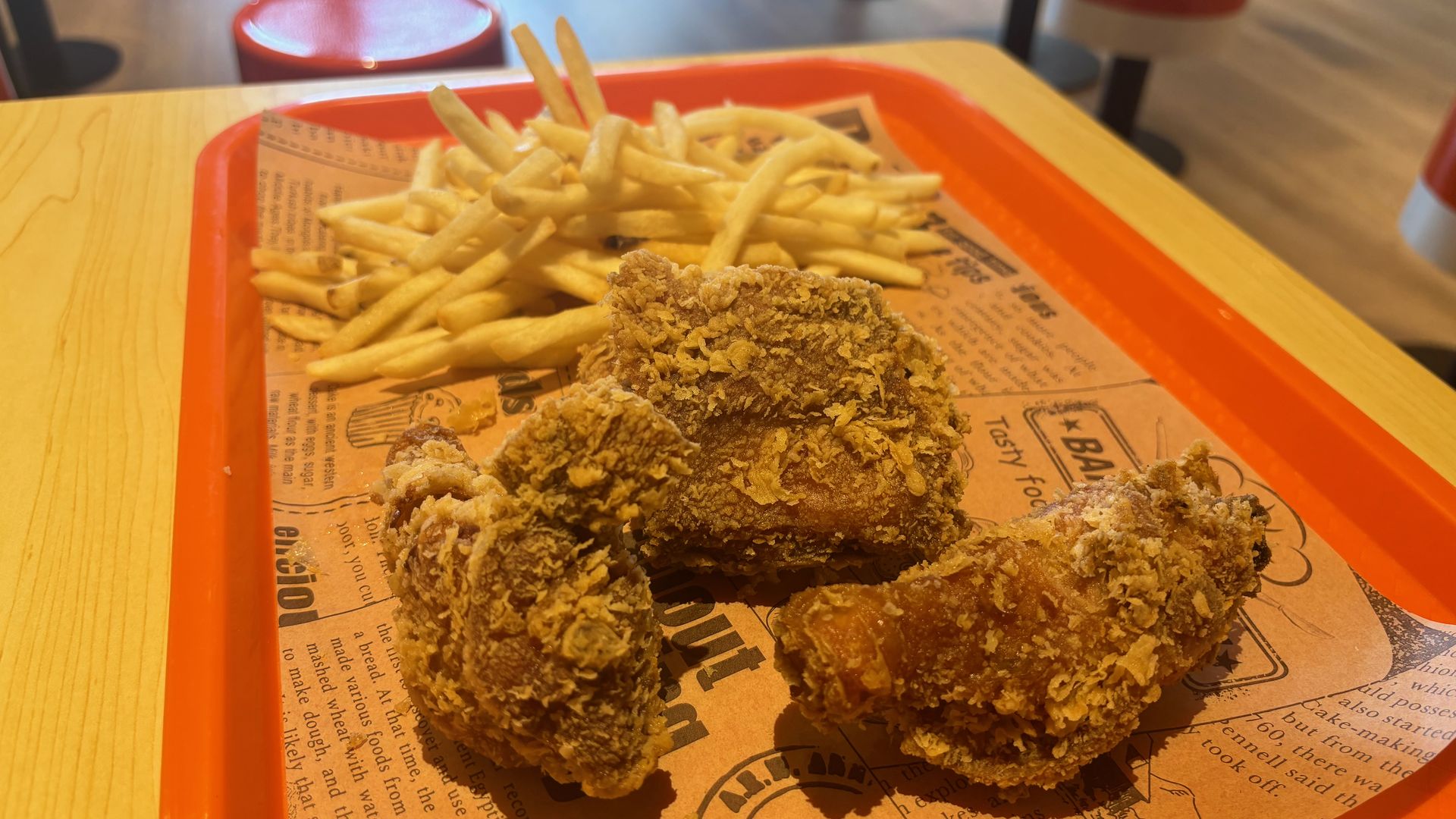 A tray with fried chicken and fries.