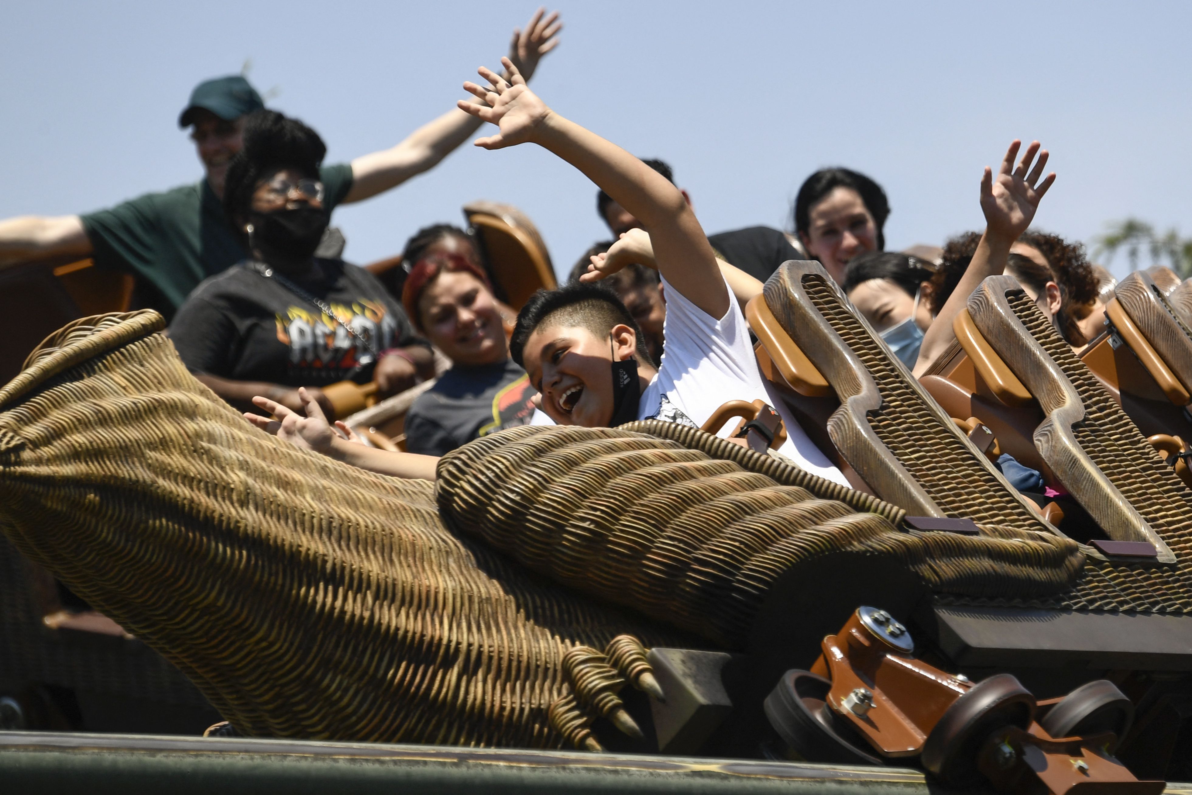 Guests ride the Flight of the Hippogriff roller coaster inside The Wizarding World of Harry Potter at the Universal Studios Hollywood theme park following the state's full reopening on June 15
