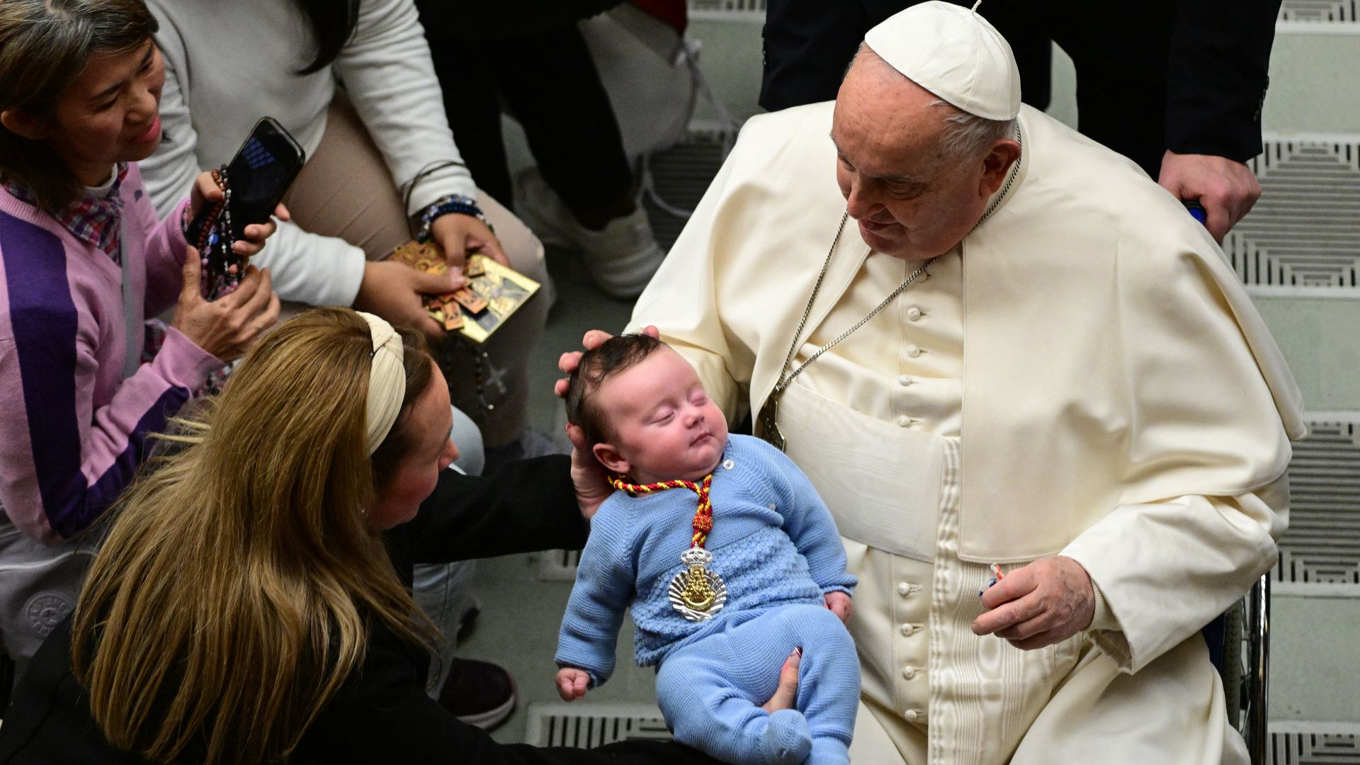 Pope Francis shown with a young baby