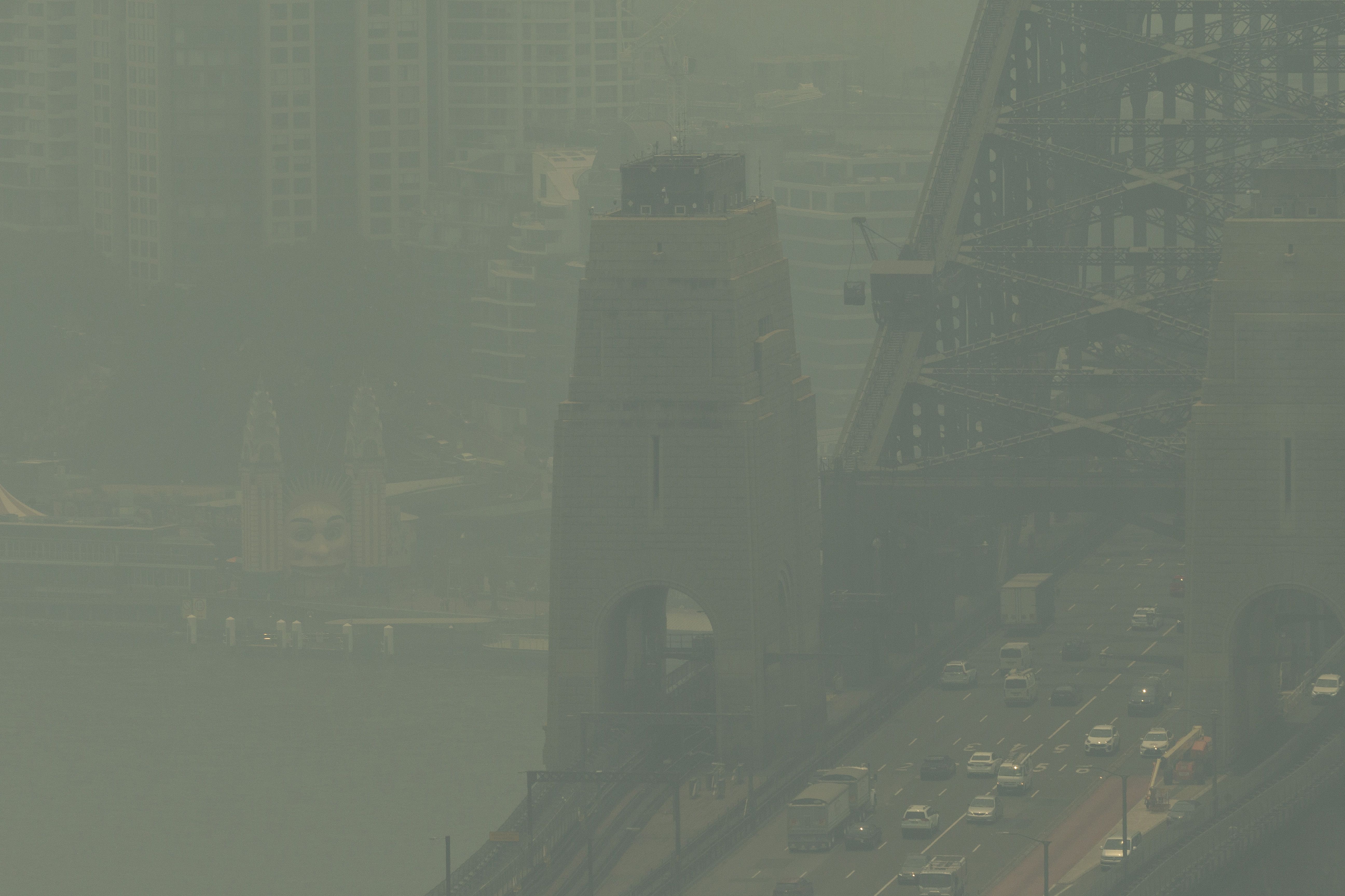 Sydney Harbour Bridge and North Sydney are covered in a blanket of smoke on December 19