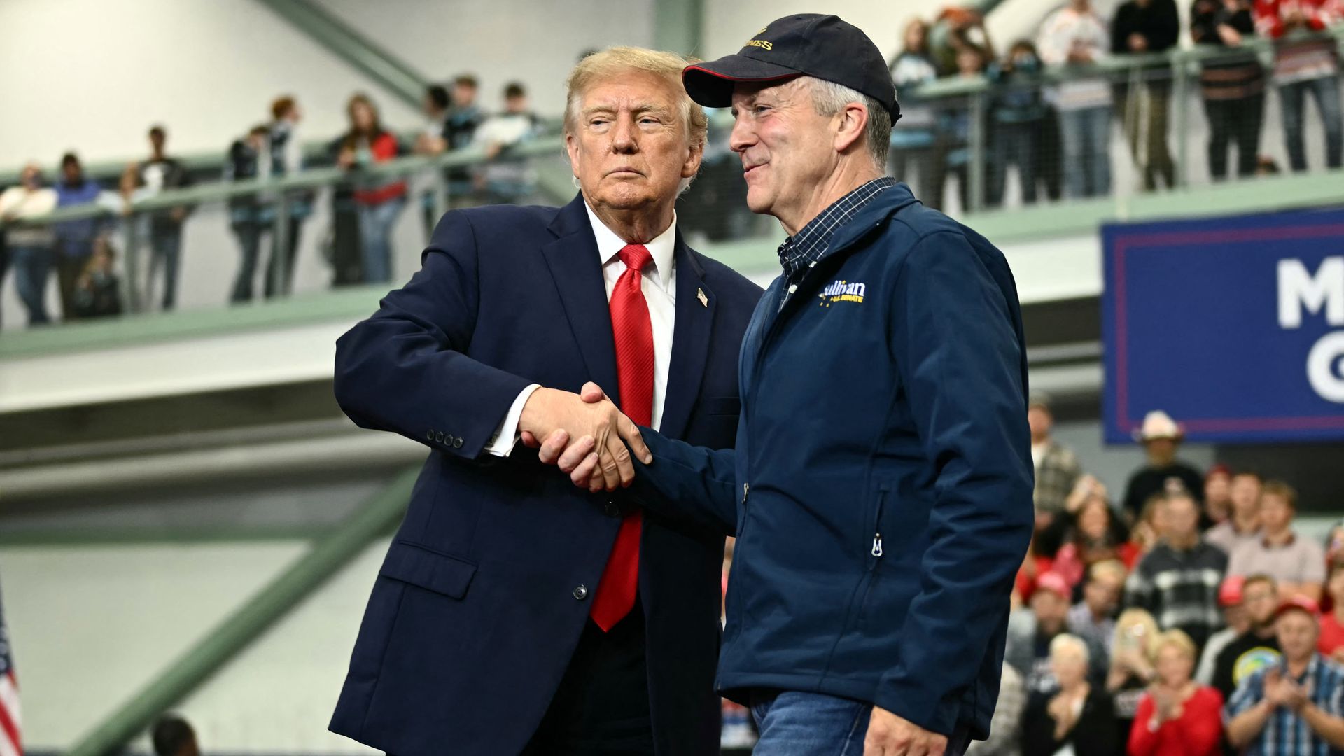 President Trump shakes hands with Sen. Dan Sullivan during a campaign rally in Wasilla, Alaska.