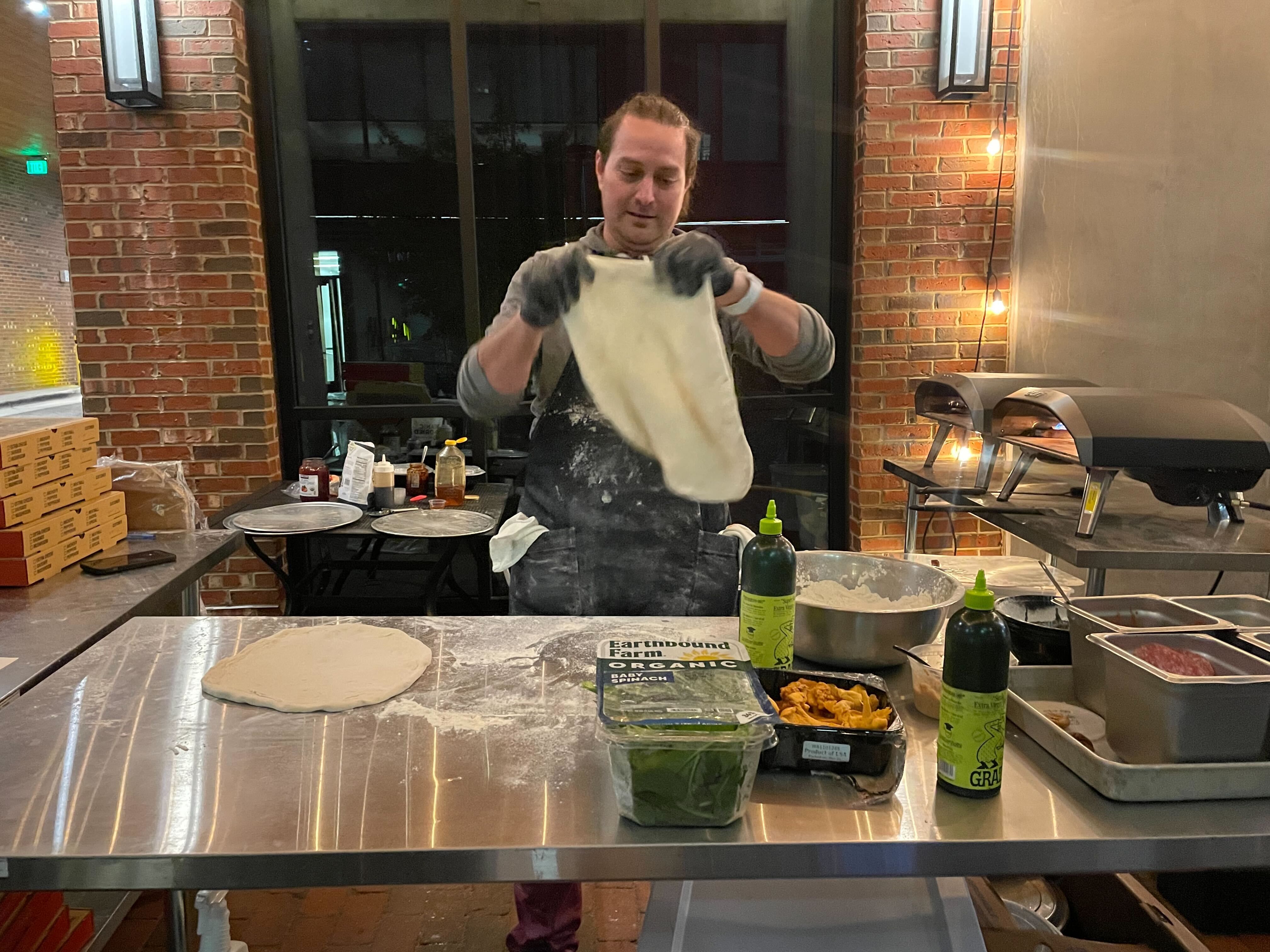 Tim Lytveninko tosses dough outside of Neighborhood