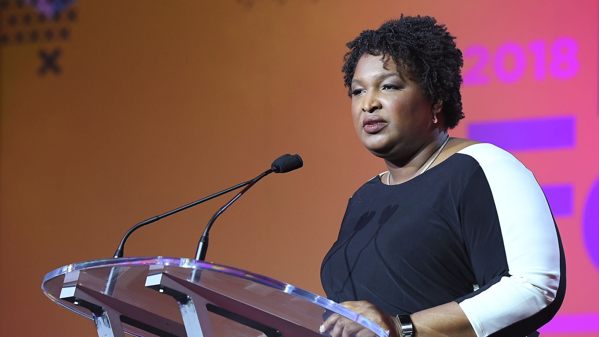 Stacey Abrams speaking at a podium.