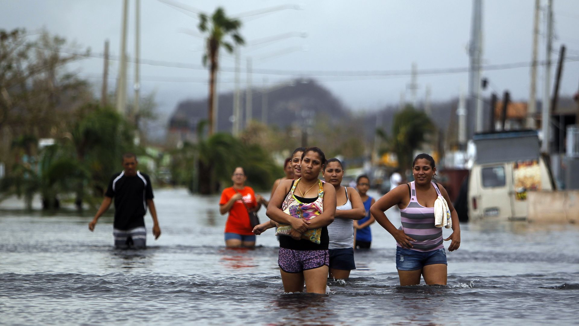 People walk on a flooded street in the aftermath of Hurricane Maria in San Juan, Puerto Rico on September 22, 2017.